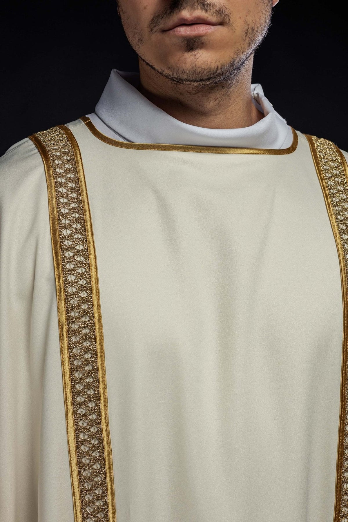 Ecru dalmatic with gold orphreys, close-up front view