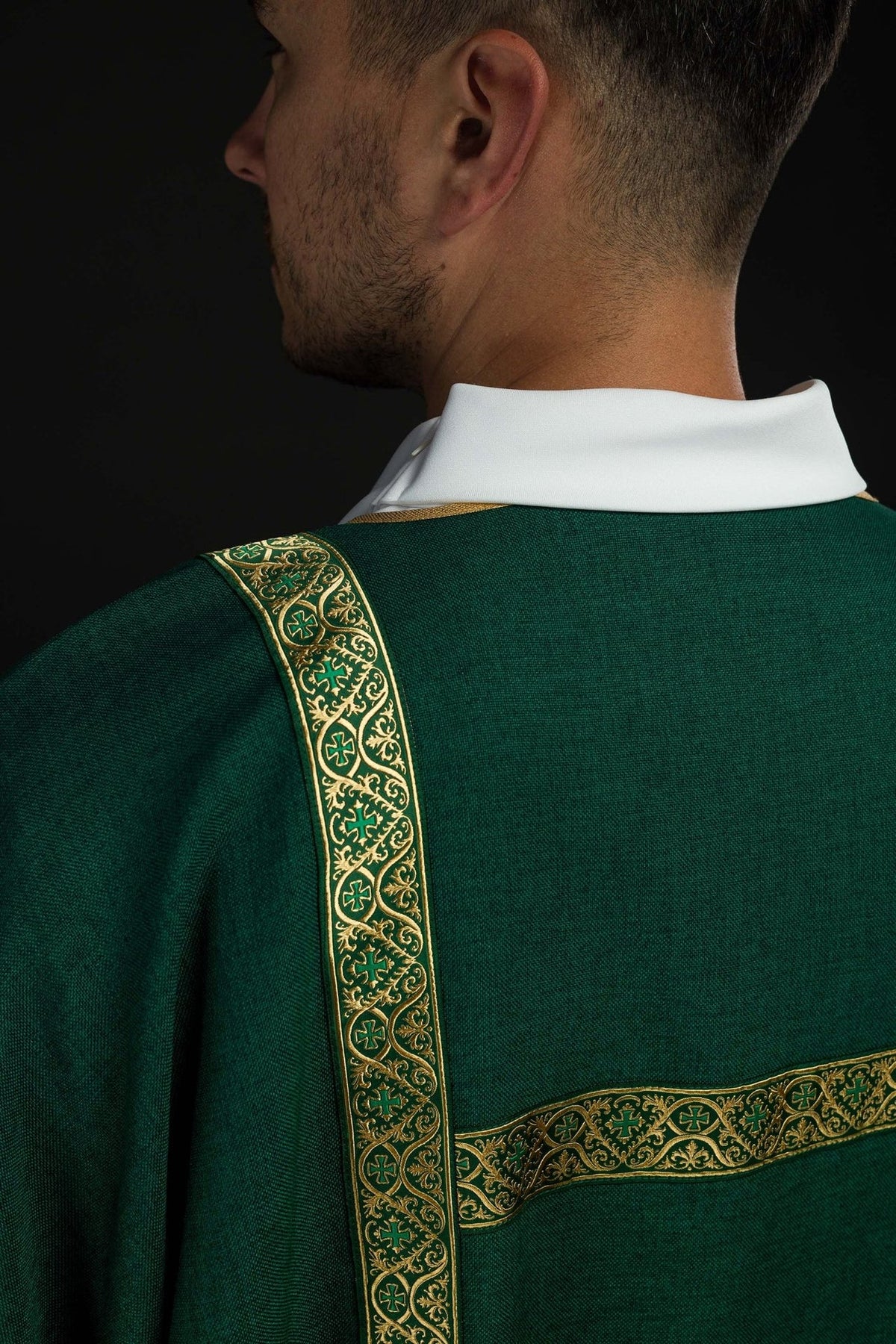 Green dalmatic sleeve close-up with gold edging and white cuff