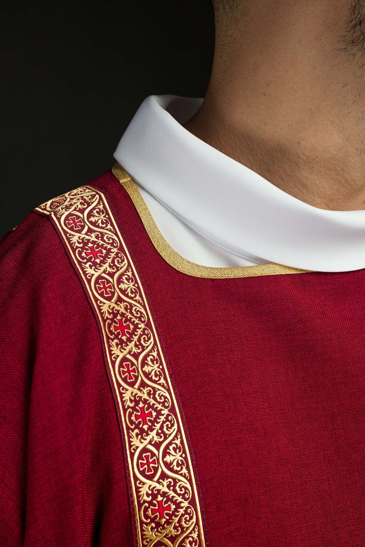 Red dalmatic close-up showing gold jacquard orphrey and trim