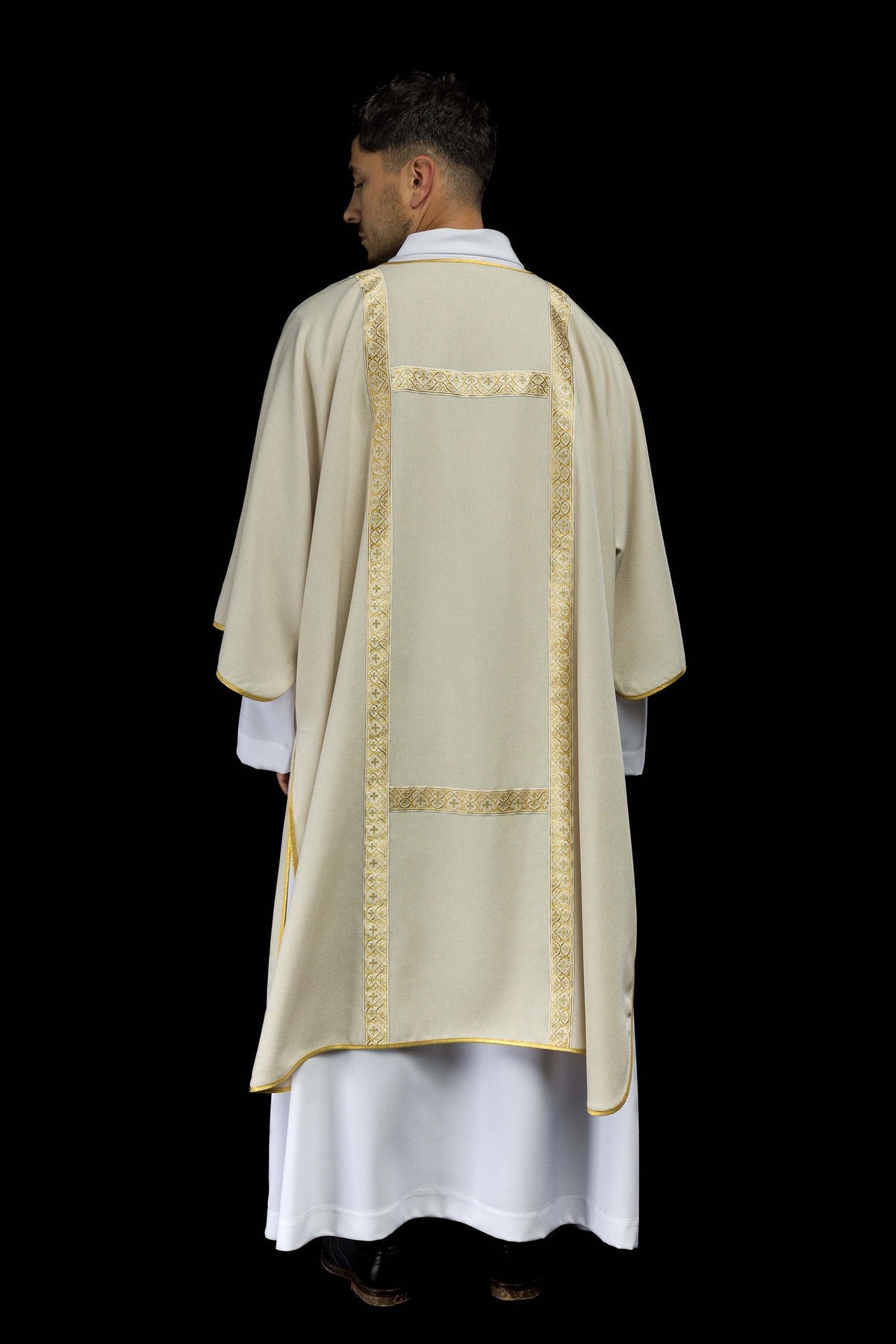 Ecru dalmatic back view with gold jacquard orphreys and horizontal trim