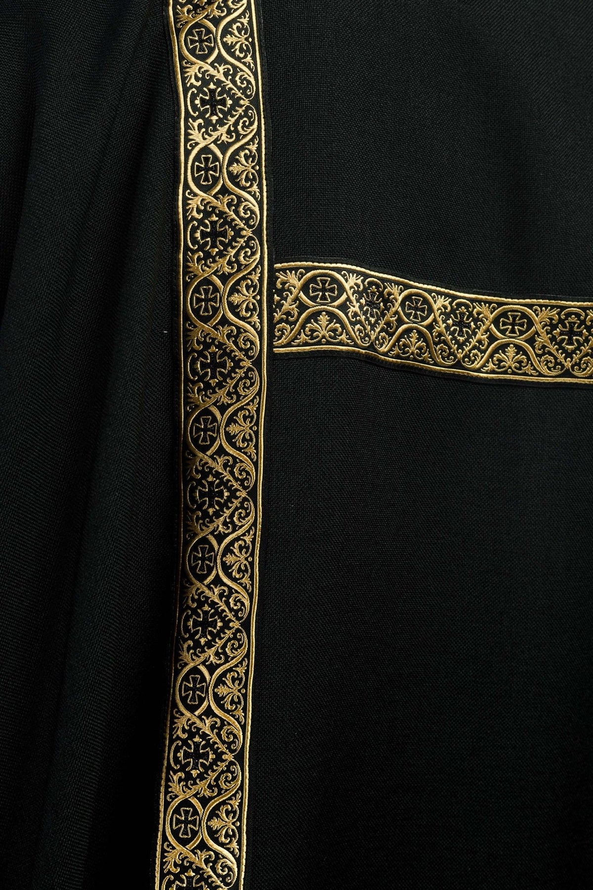 Black dalmatic front detail with gold jacquard orphreys and gold trim