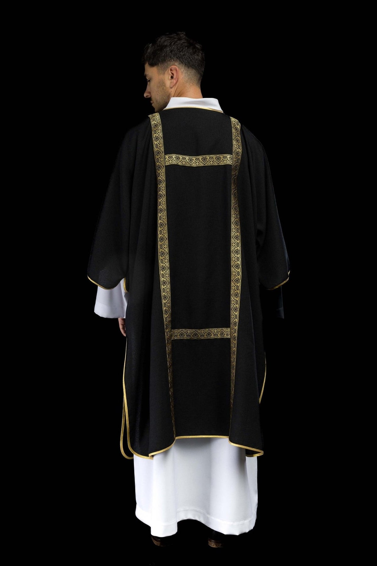 Black dalmatic worn back view with gold jacquard orphreys