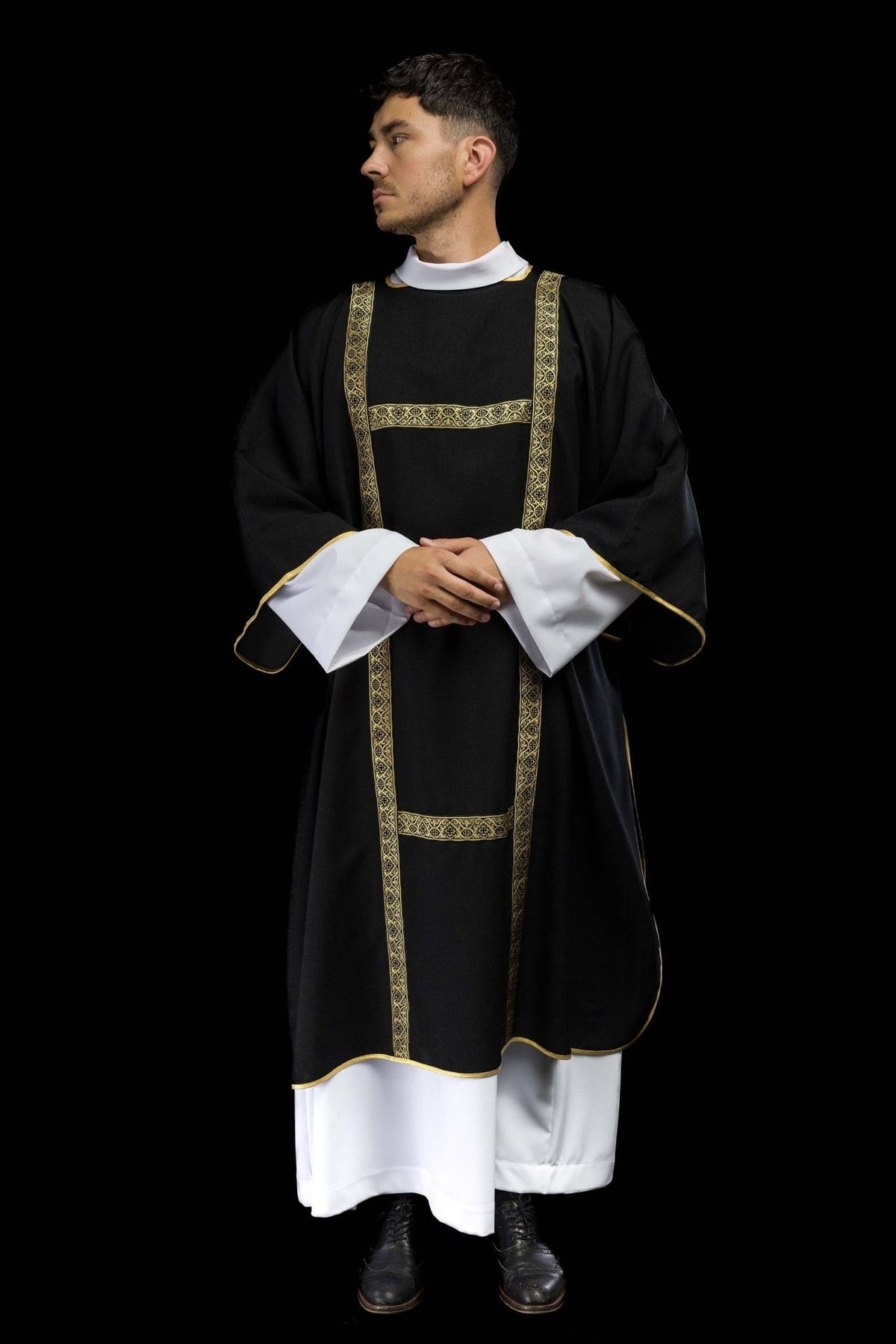 Black dalmatic worn front view with gold jacquard orphreys