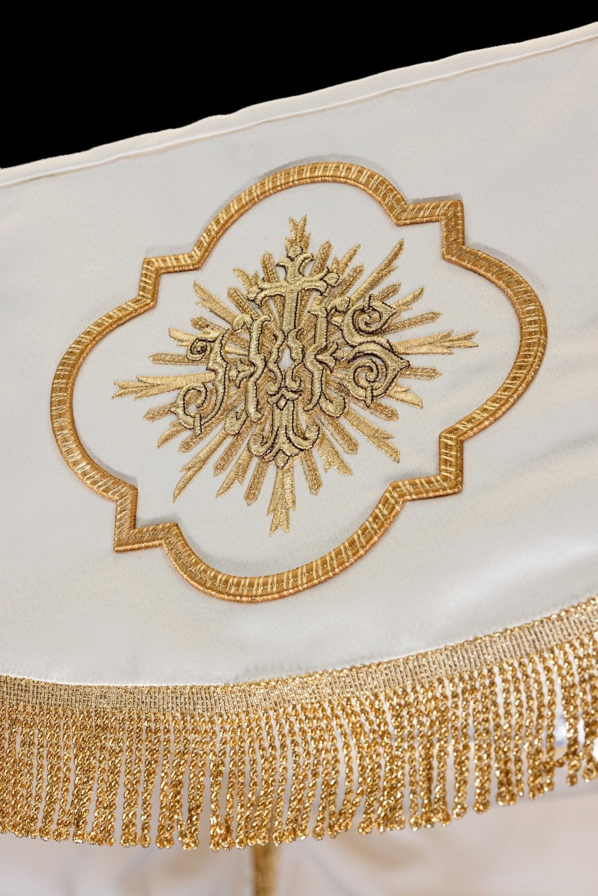 Canopy close-up with embroidered Corpus Christi medallion and gold fringe