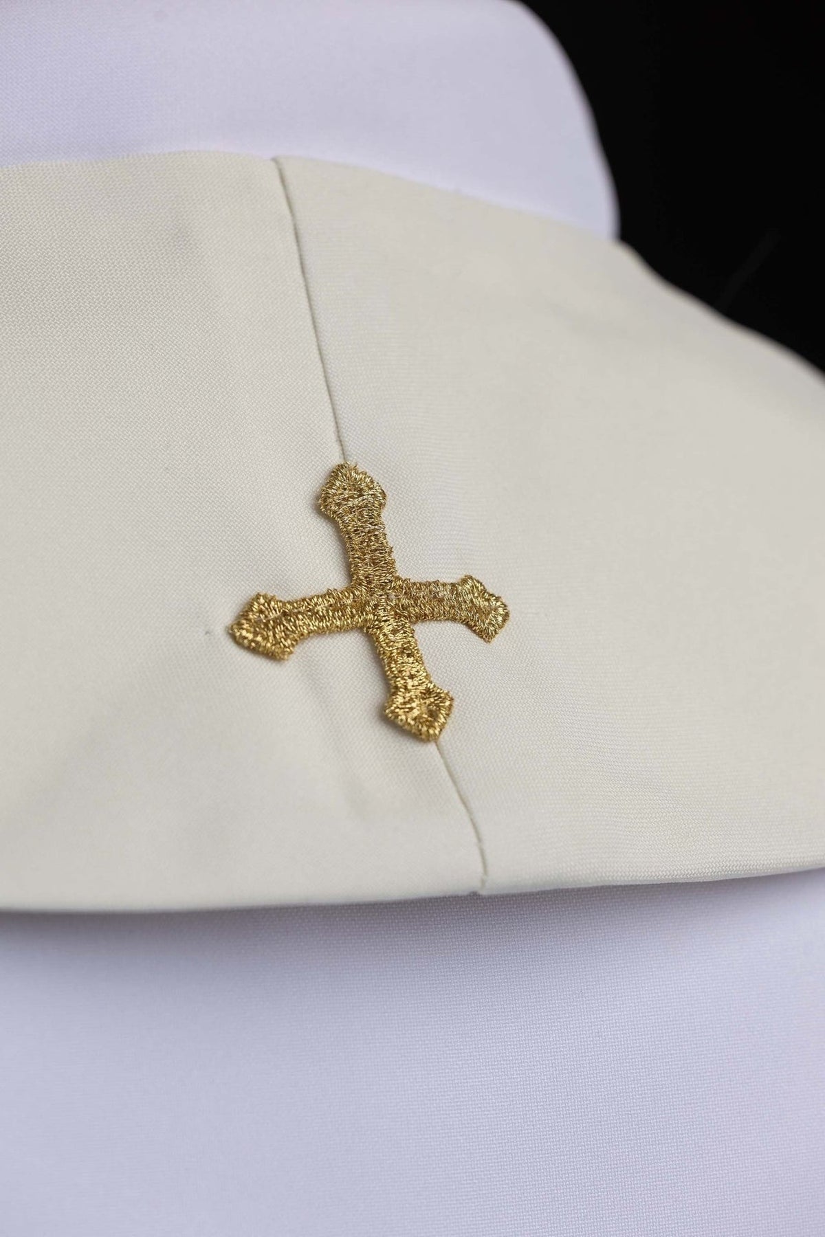 Ecru Marian stole close-up with a gold embroidered cross at the neck