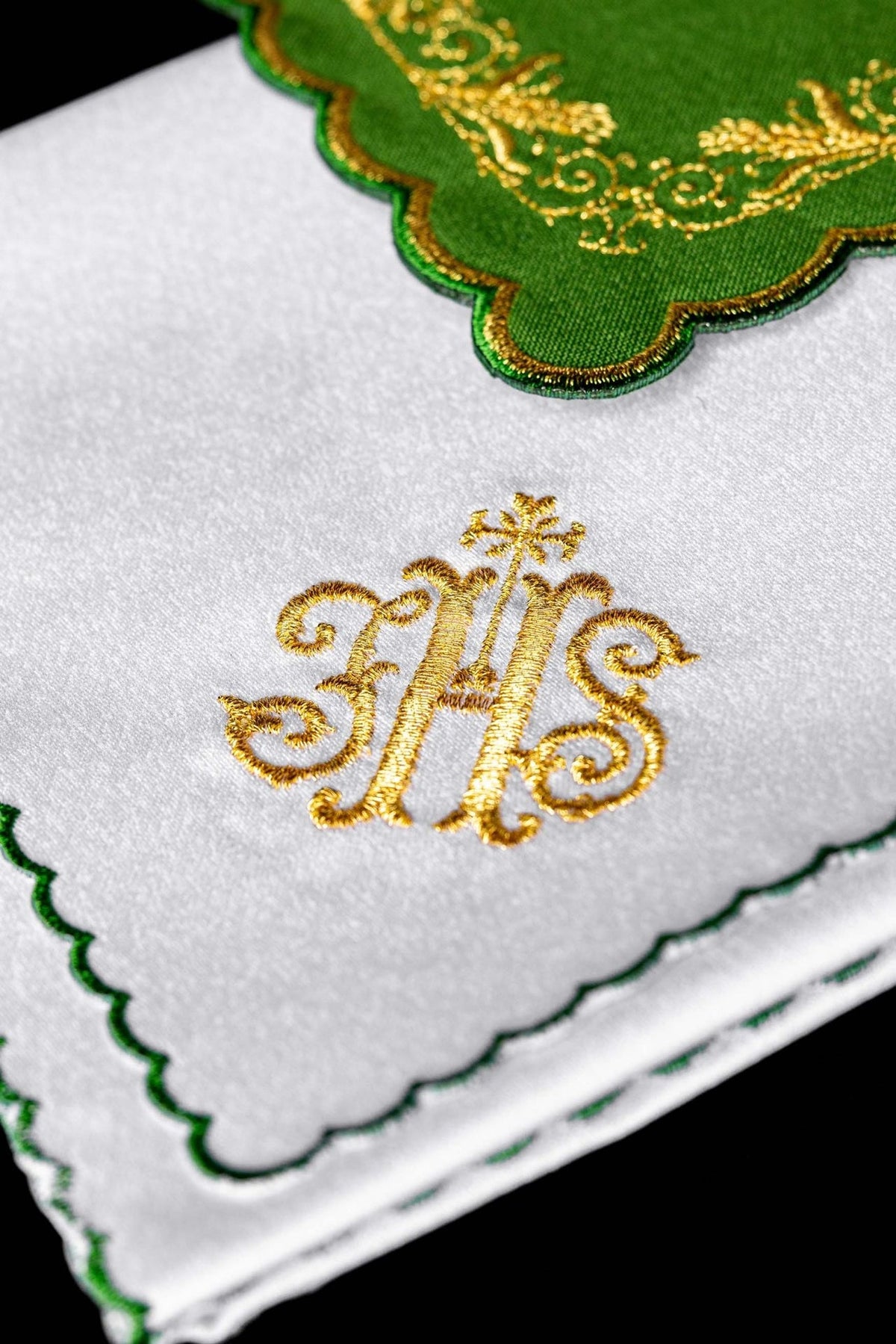 Altar linen set close-up showing gold IHS monogram on white linen with green edging