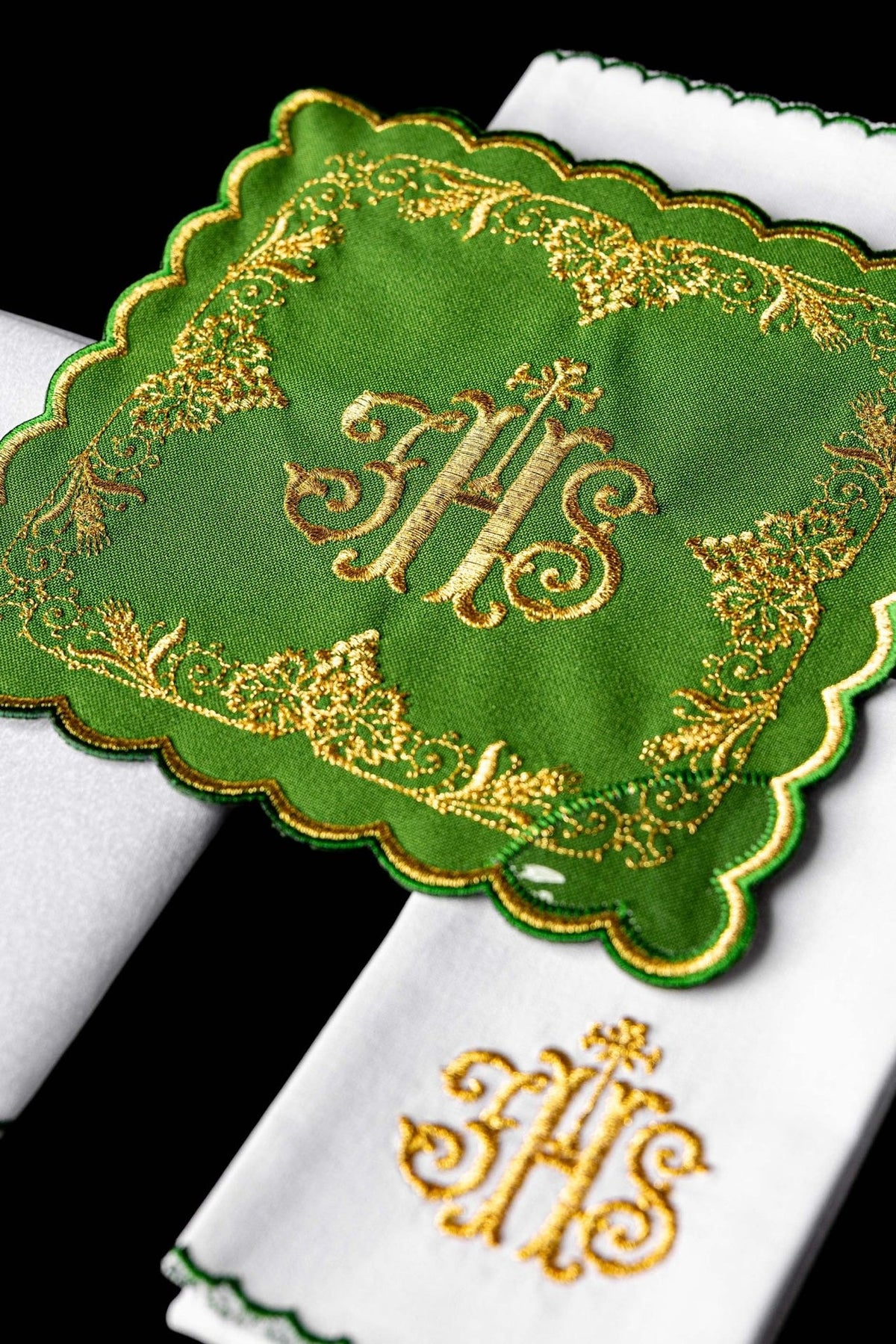 Altar linen set detail showing scalloped green panel with gold embroidery over white linen