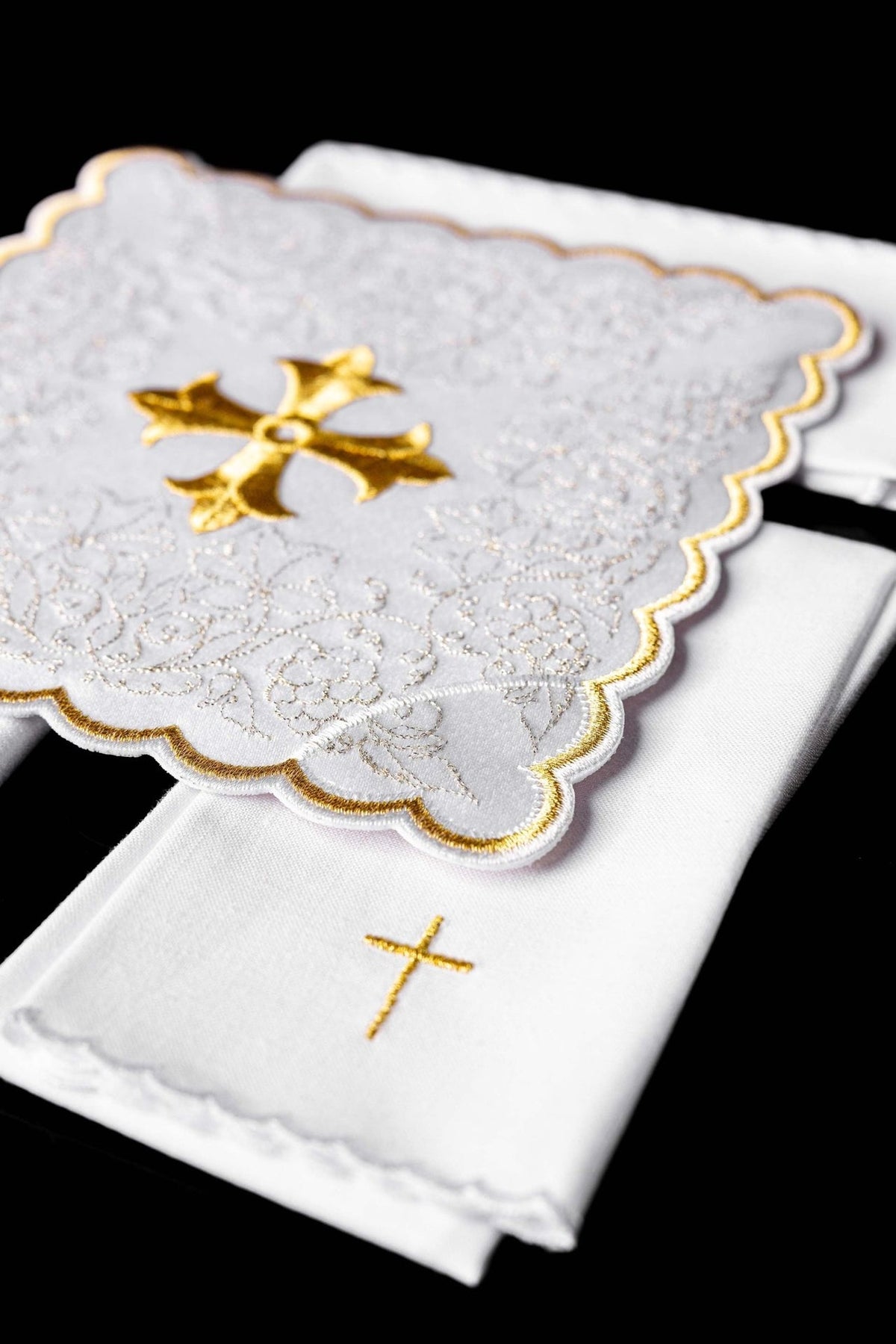 Altar linen set folded view showing gold cross, floral embroidery and scalloped edges