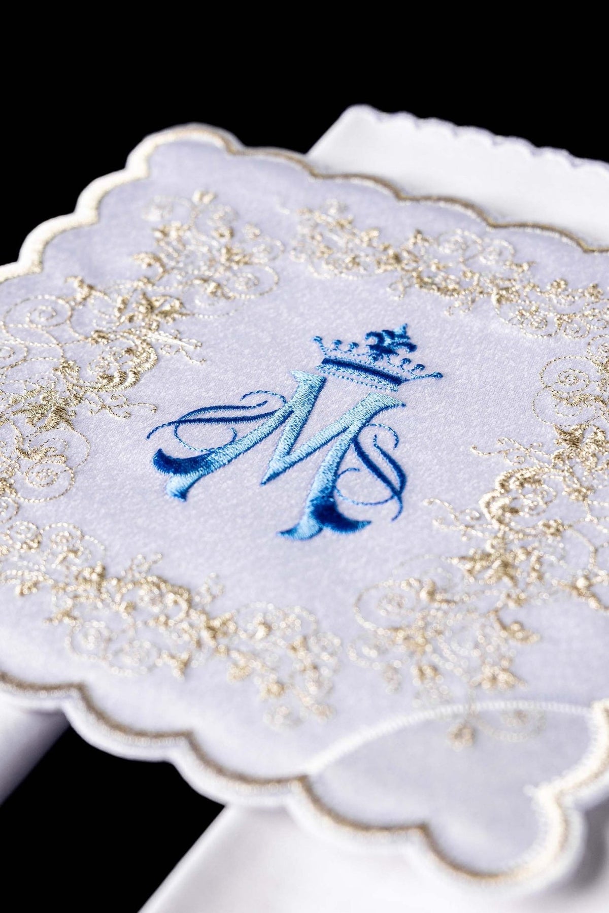 Altar linen set close-up showing blue Marian motif and gold embroidery on white fabric