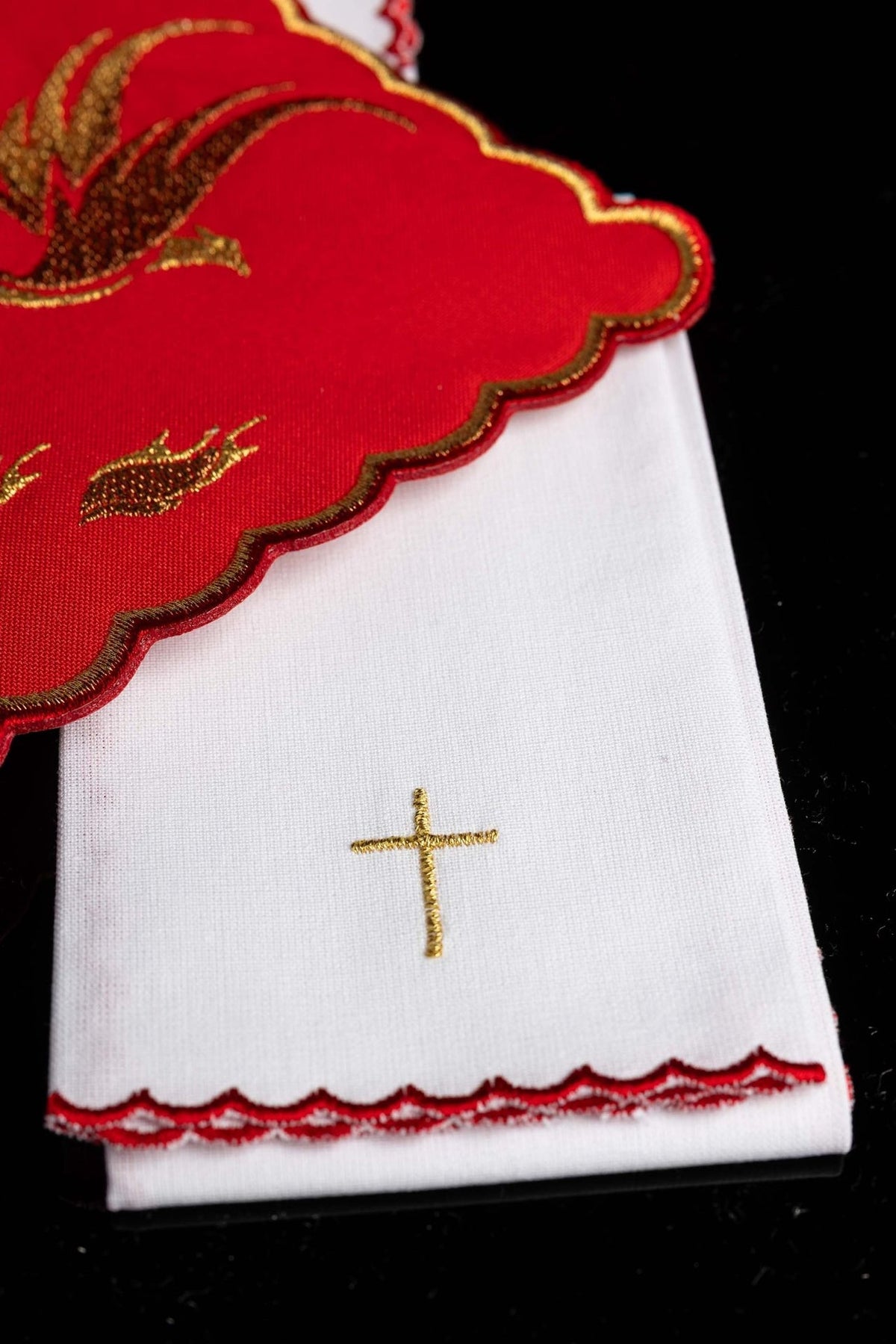 Altar linen set detail showing embroidered Holy Spirit and gold cross on white linen