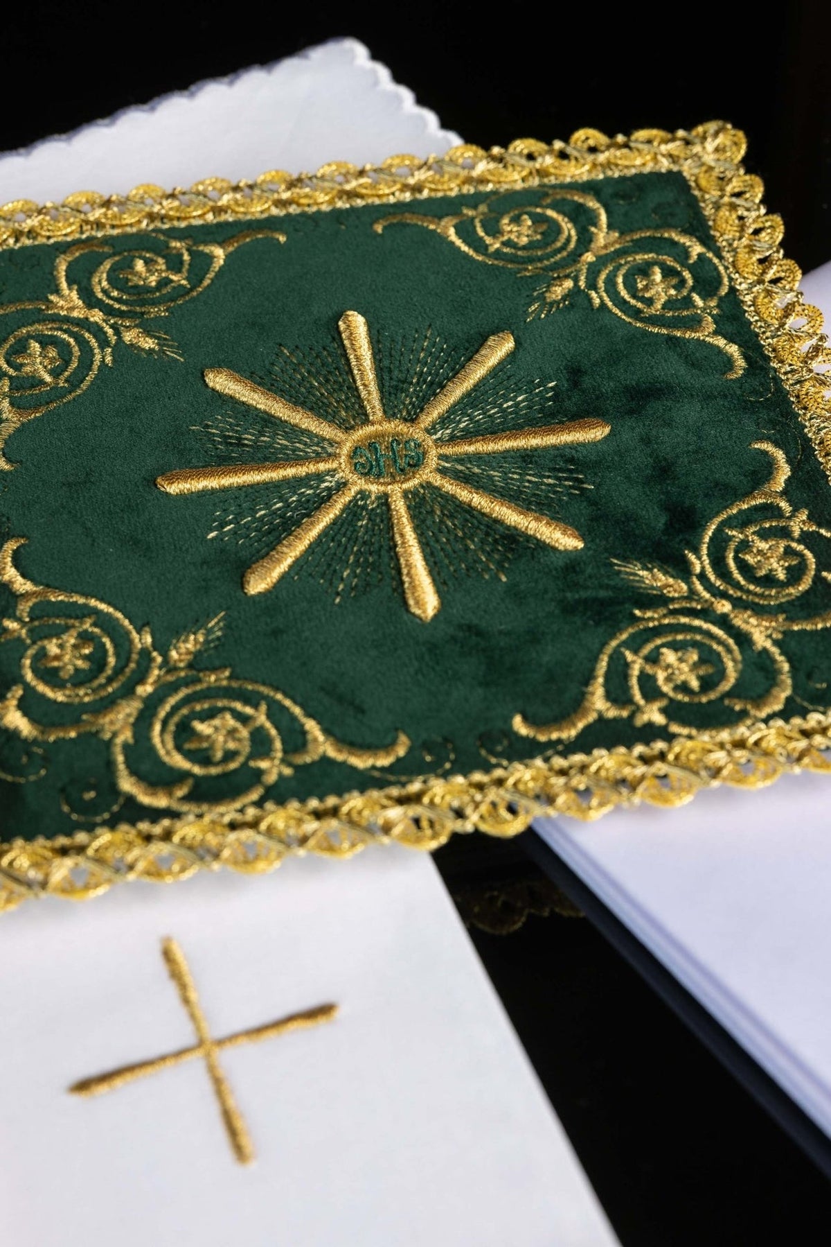 Altar linen set close-up showing green velvet IHS monogram and gold embroidery