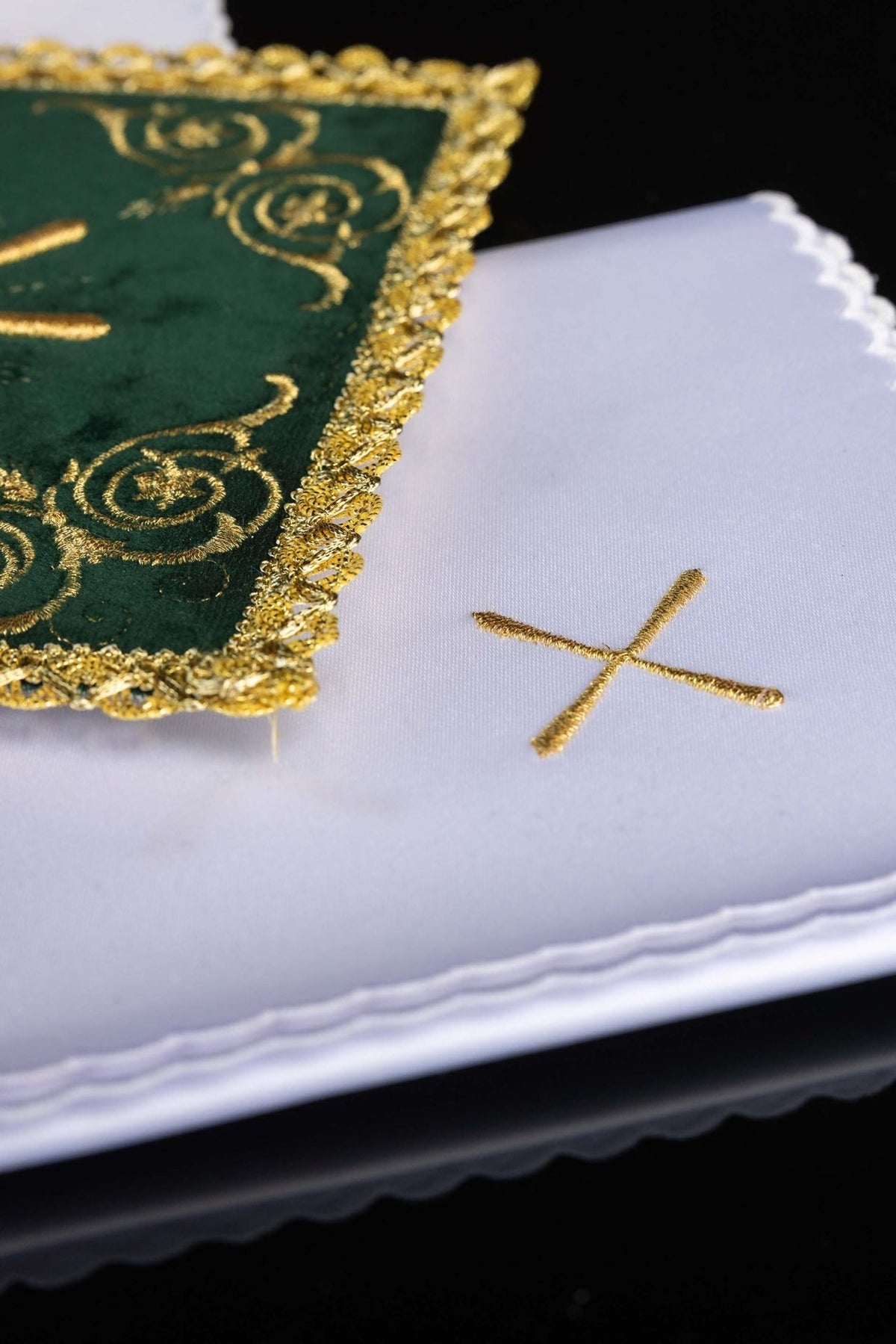Altar linen set detail showing gold cross embroidery and scalloped white linen edge