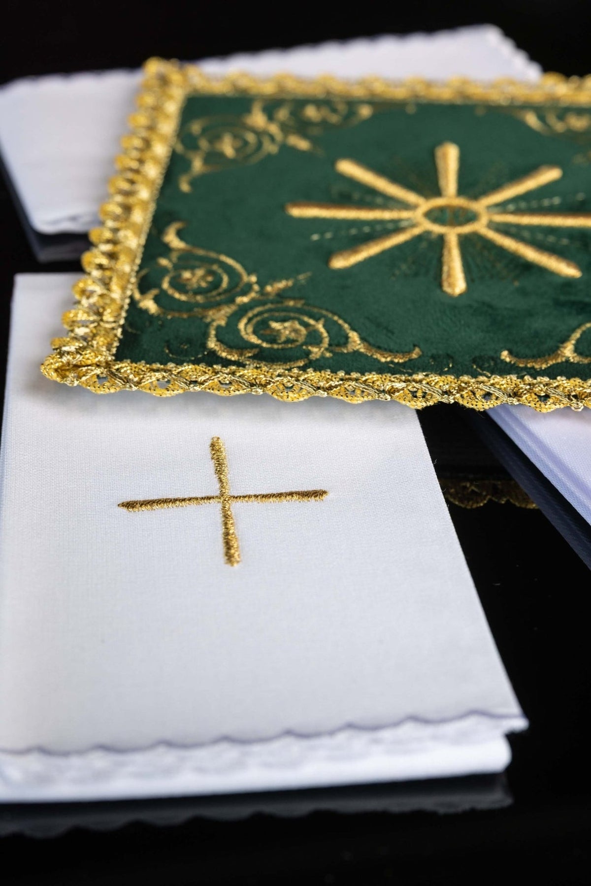 Green velvet altar linen set detail showing IHS monogram, gold rays and decorative embroidery
