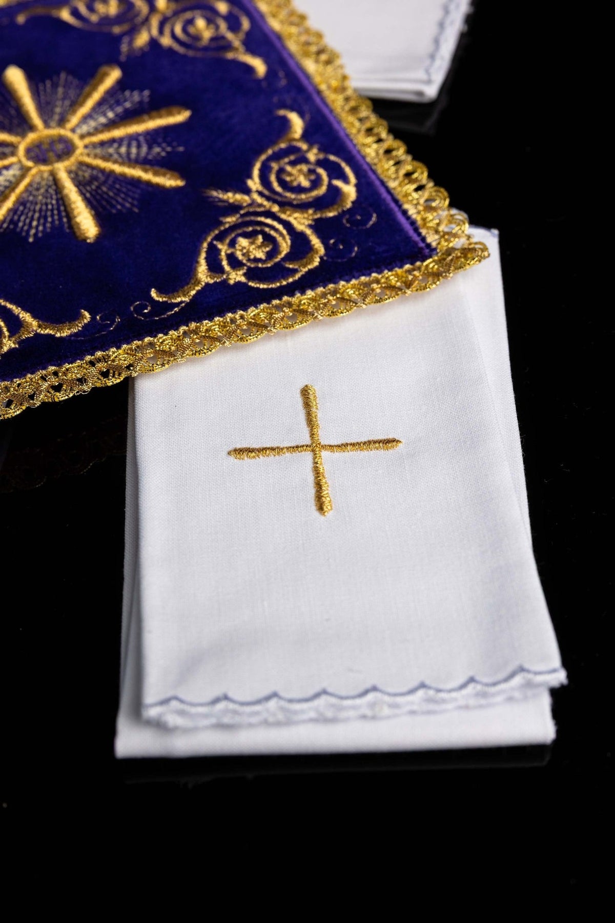 White altar linen with gold cross and scalloped embroidered edge