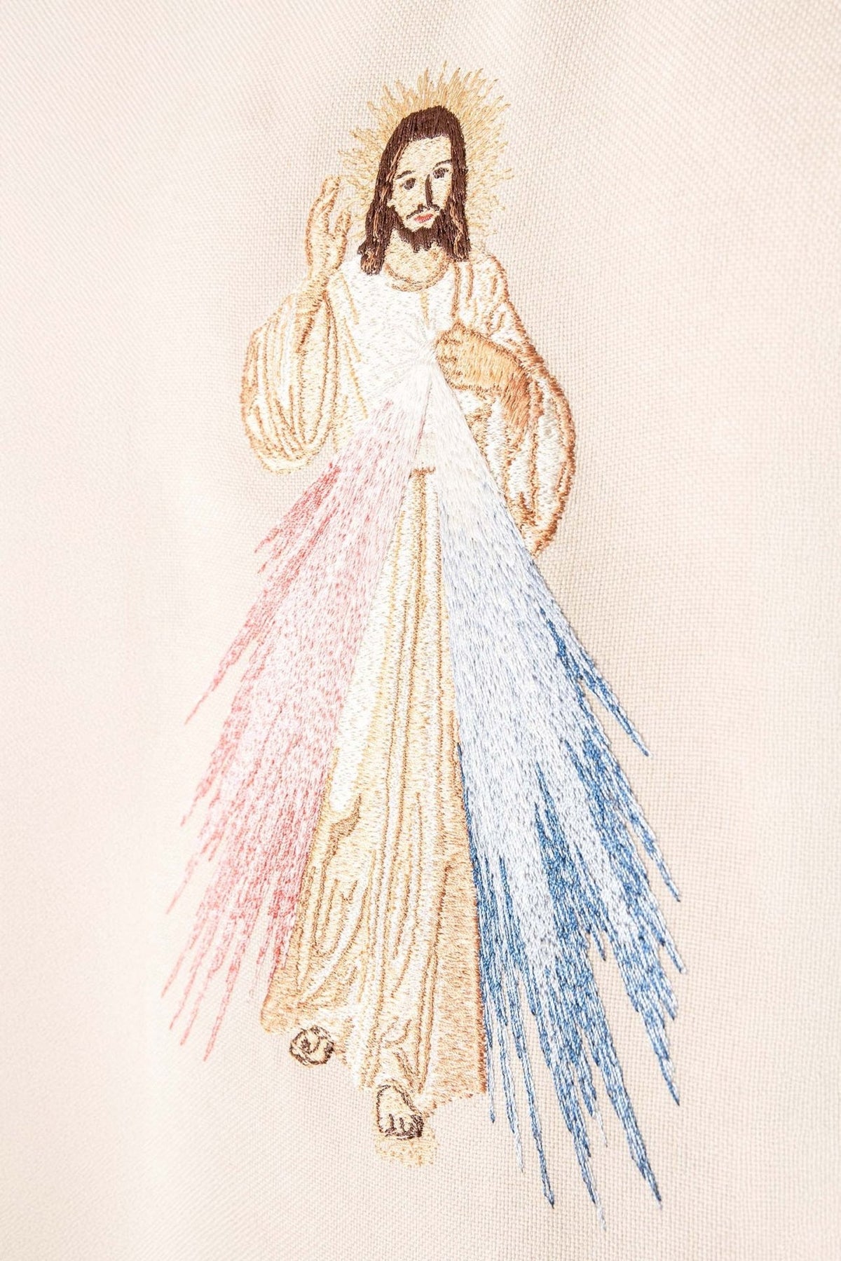 Ecru chasuble close-up of embroidered Divine Mercy image with red and blue rays