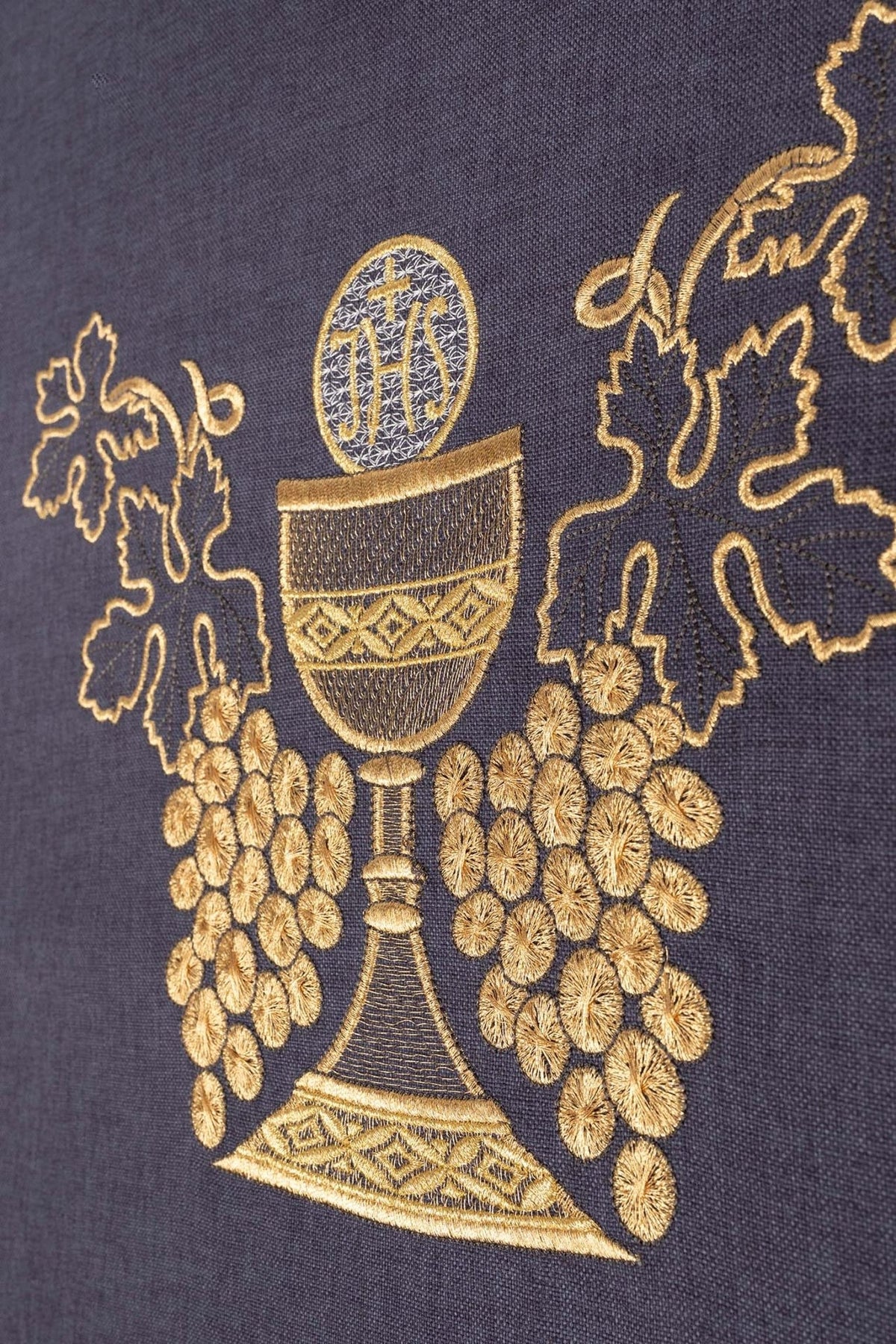 Chasuble close-up showing gold embroidered chalice and grapes