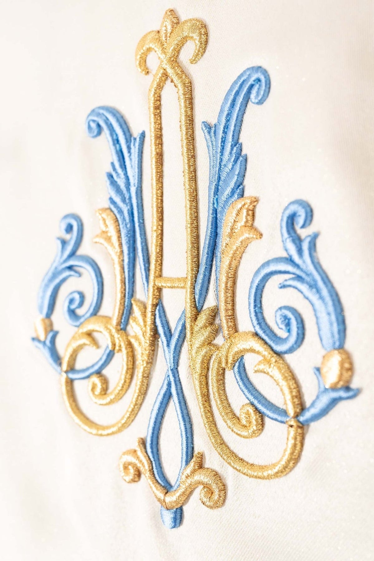 Marian chasuble close-up of blue and gold embroidered Marian motif