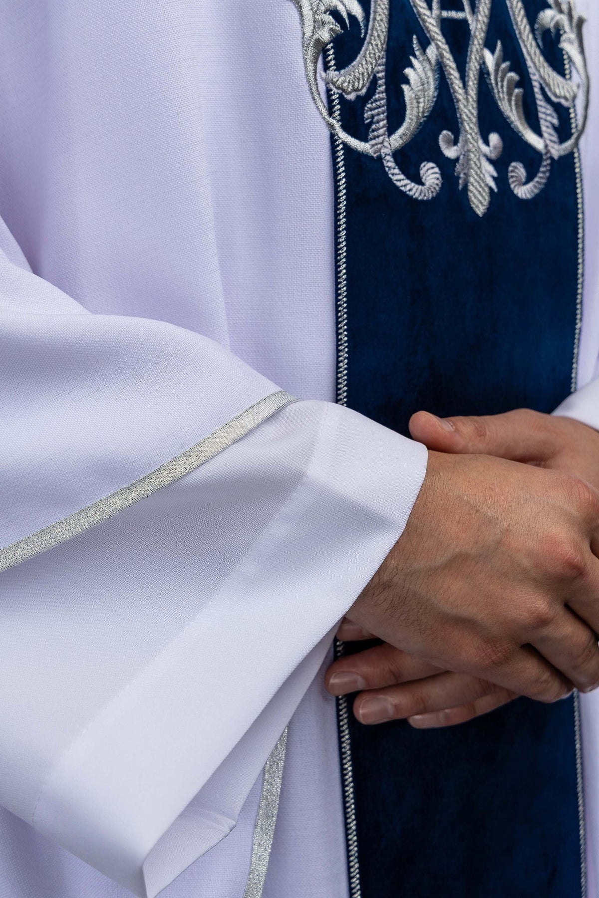 Marian chasuble sleeve close-up with silver edge trim and blue velvet orphrey