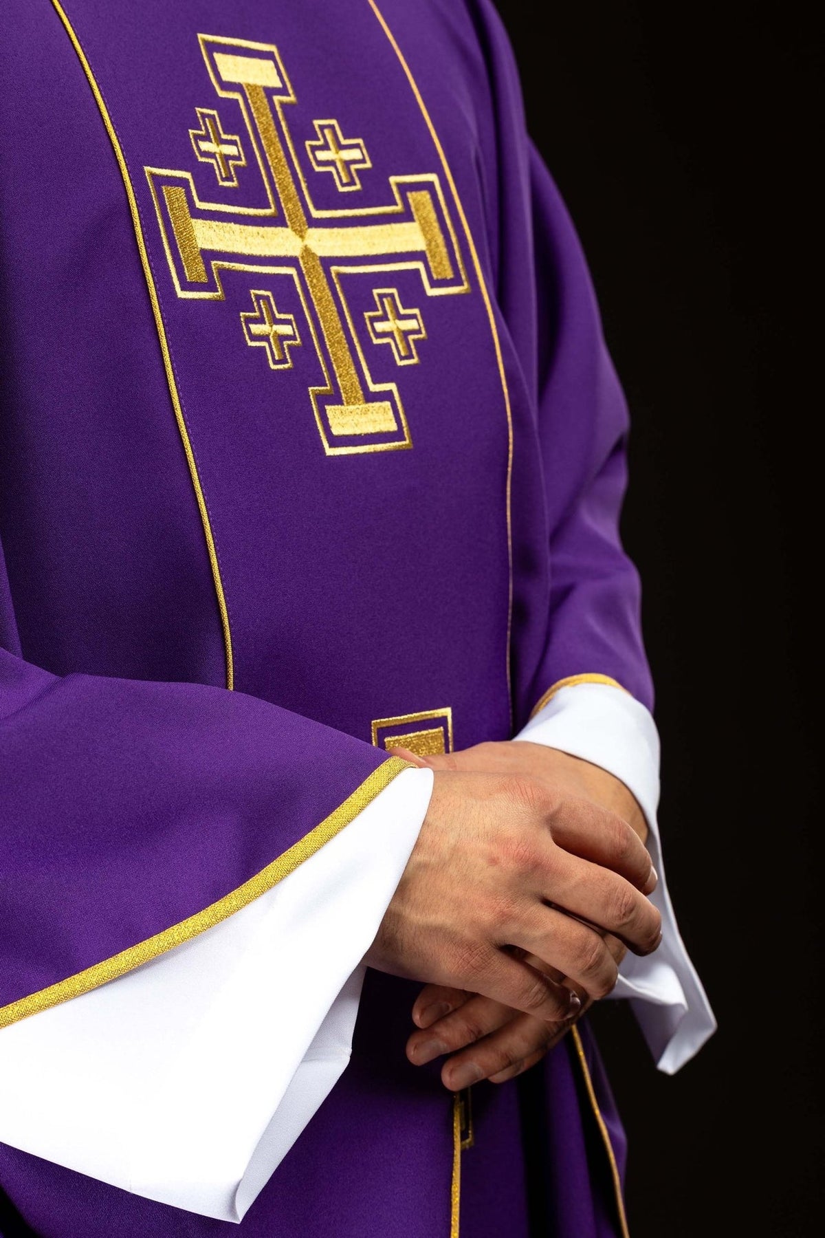 Purple chasuble detail showing gold cross embroidery, orphrey and sleeve trim