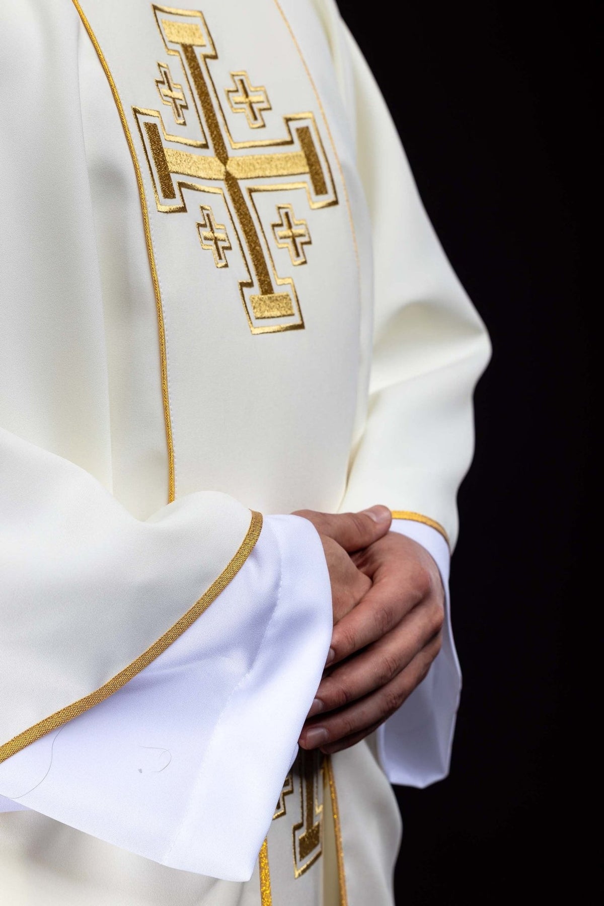 Ecru chasuble side view showing gold trim and embroidered cross