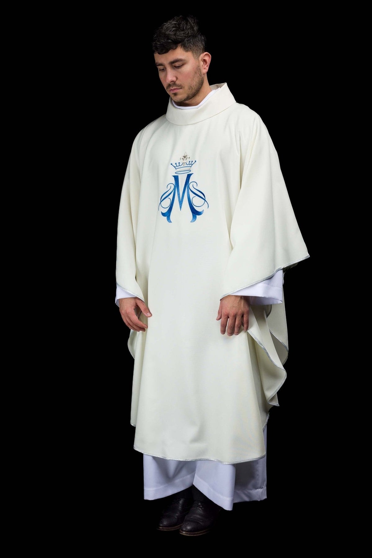Marian chasuble worn full length, ecru with blue embroidered Marian motif and silver trim