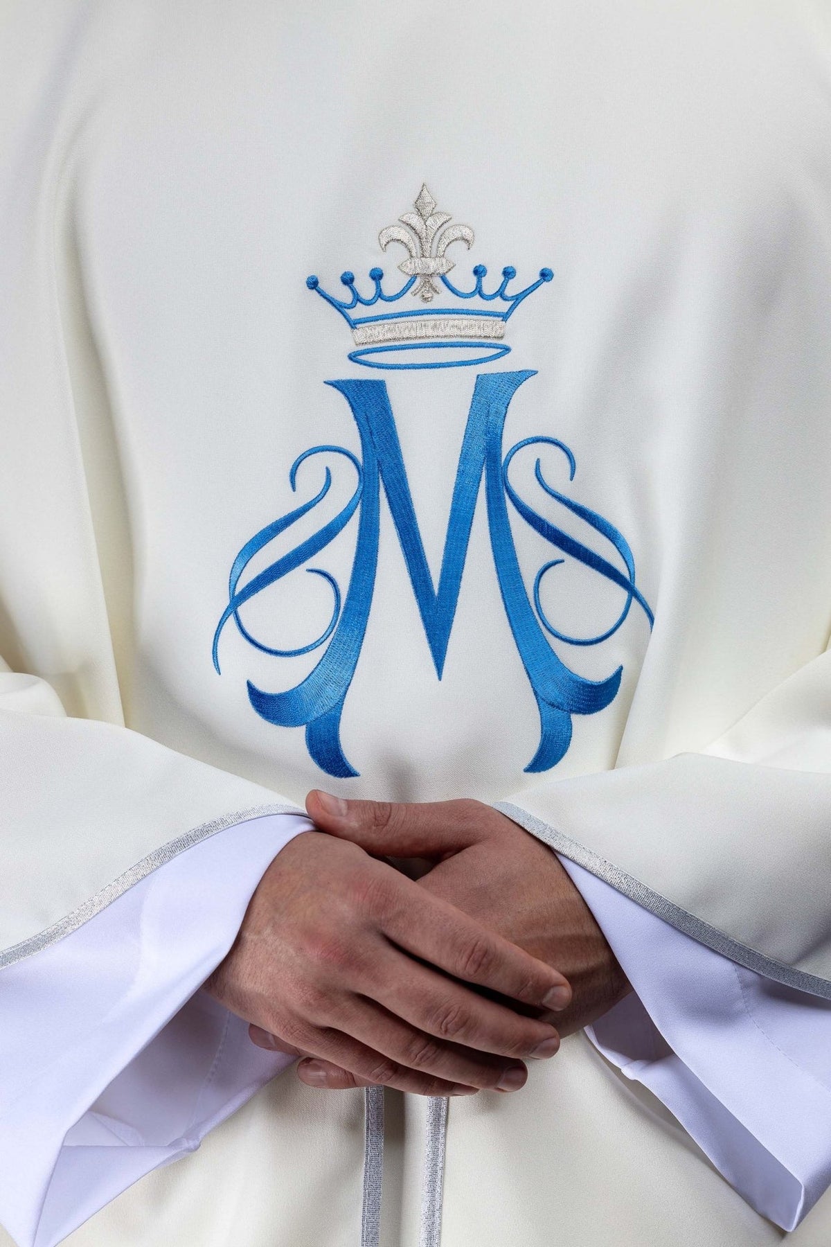 Marian chasuble front close-up showing blue embroidered Marian motif with crown