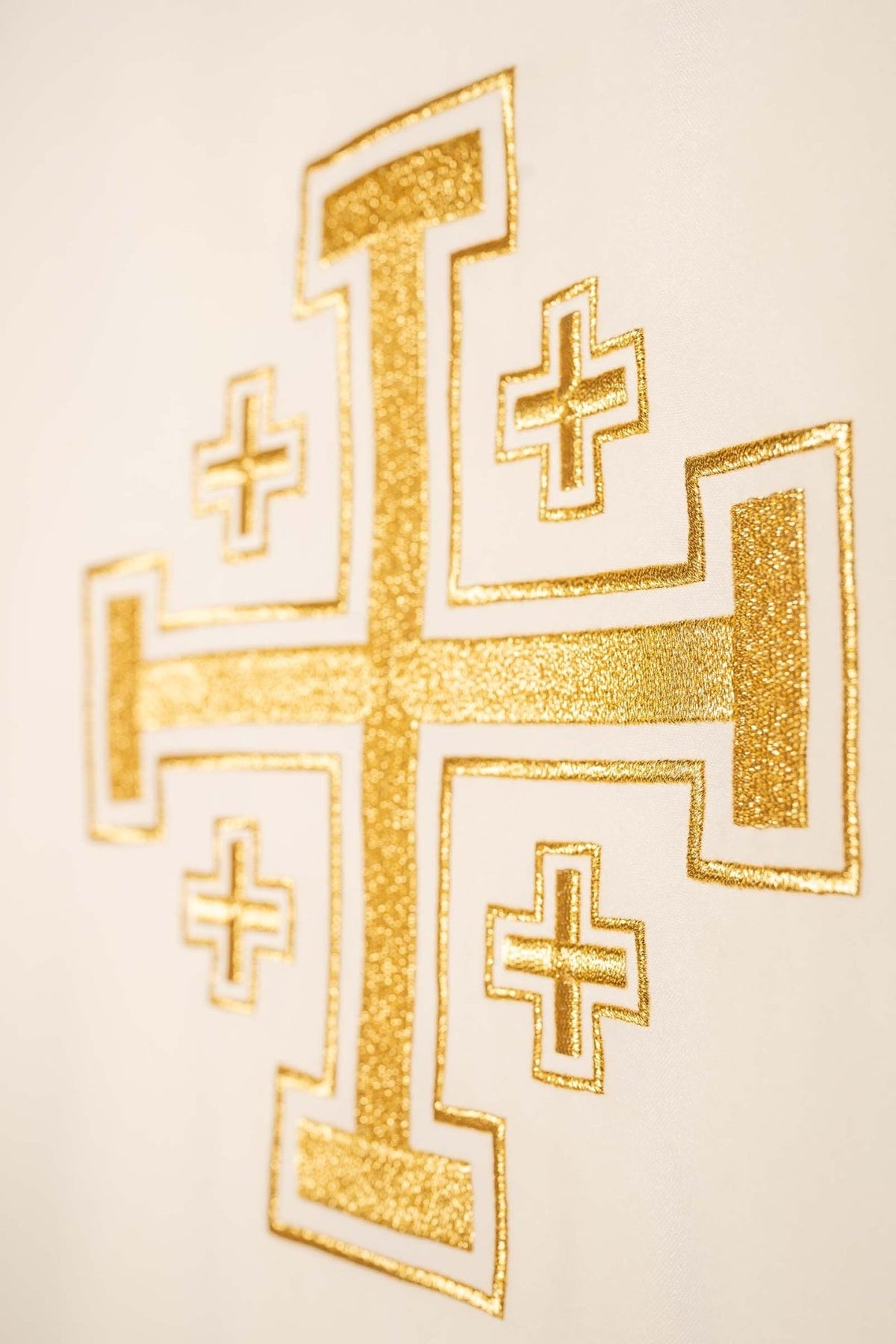 Ecru chasuble close-up of gold cross embroidery with smaller crosses