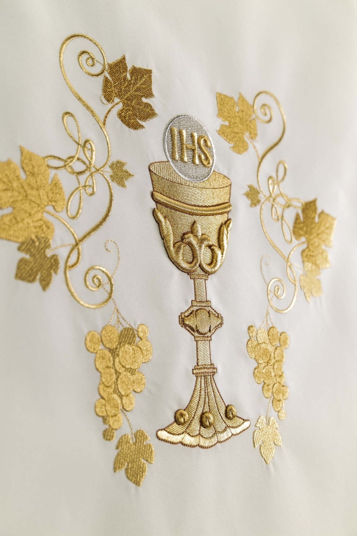 Church lectern cover detail showing gold embroidered chalice, grapes and vine motifs