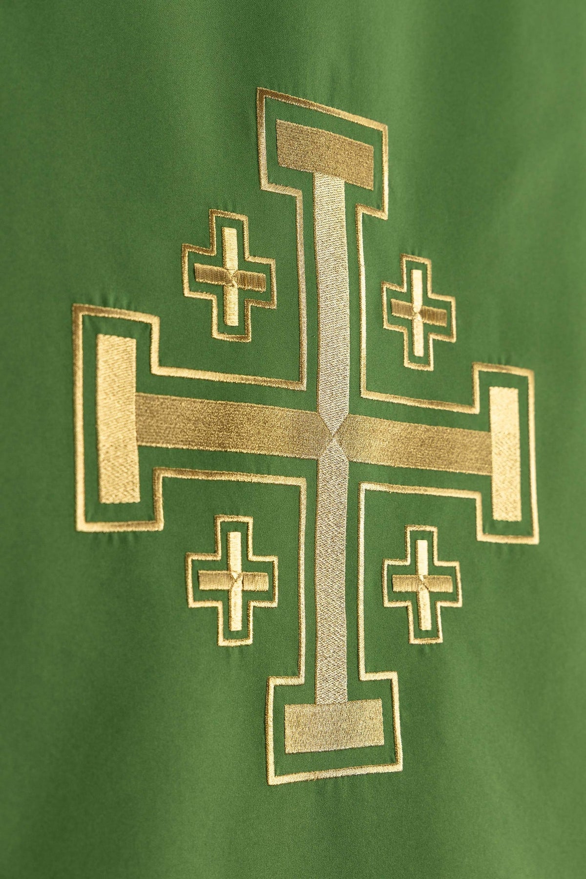 Church lectern cover close-up of Jerusalem cross embroidery on green fabric