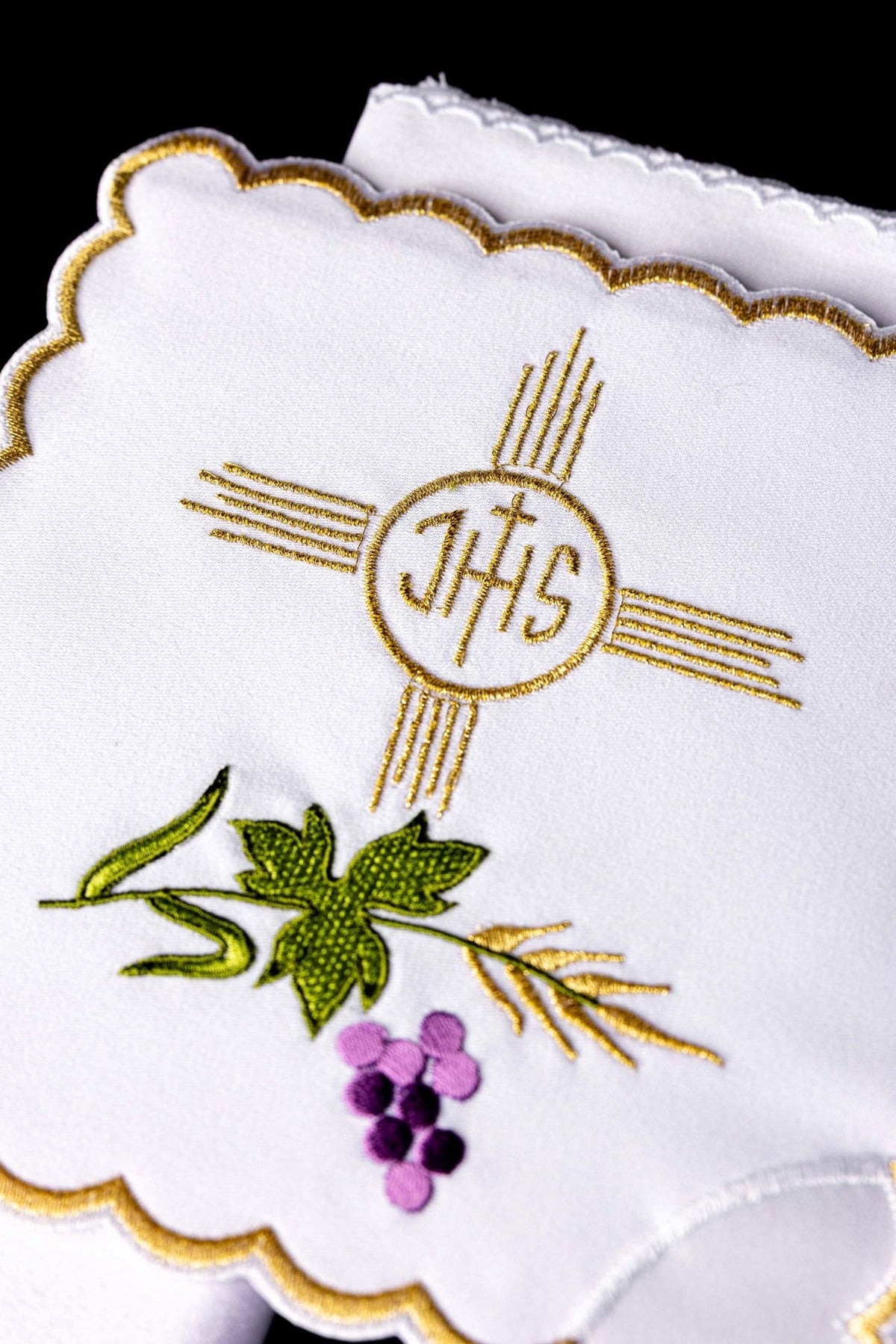 Altar linen set close-up with embroidered gold IHS emblem, grape motif and scalloped gold edging