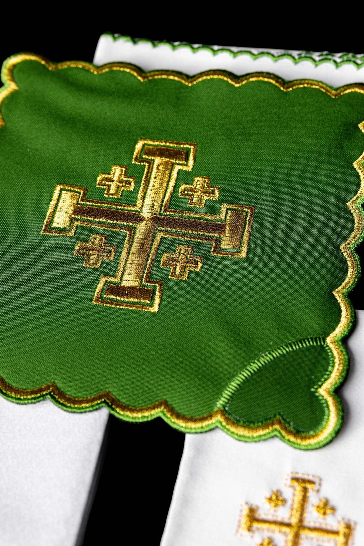 Altar linen set close-up showing embroidered gold Jerusalem cross on green linen