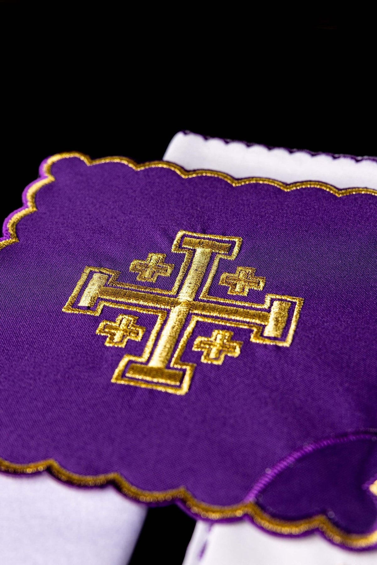 Altar linen set close-up showing purple fabric and gold Jerusalem cross embroidery