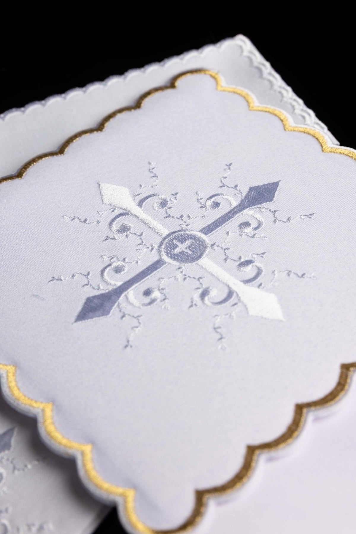 Altar linen set close-up of silver cross embroidery and gold-edged scalloped border