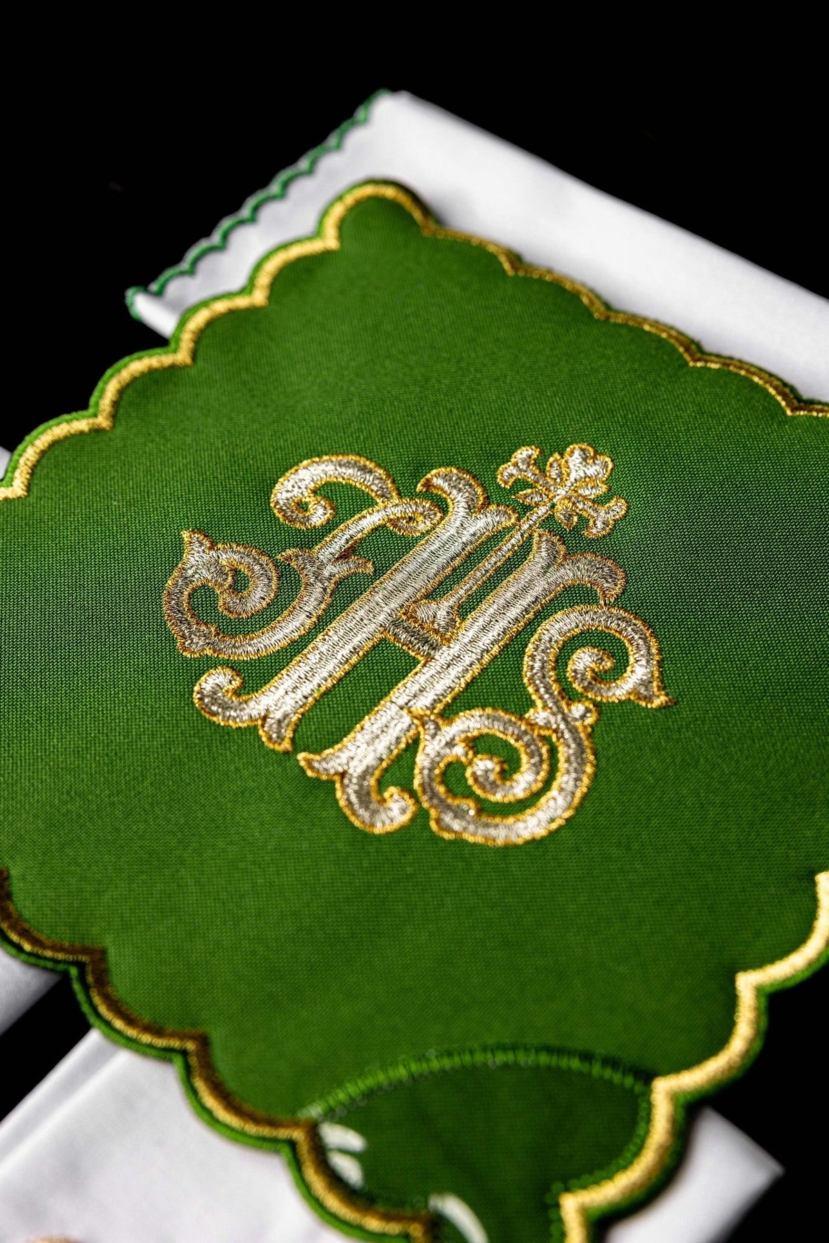 Green chalice pall close-up with gold IHS embroidery and scalloped gold edging