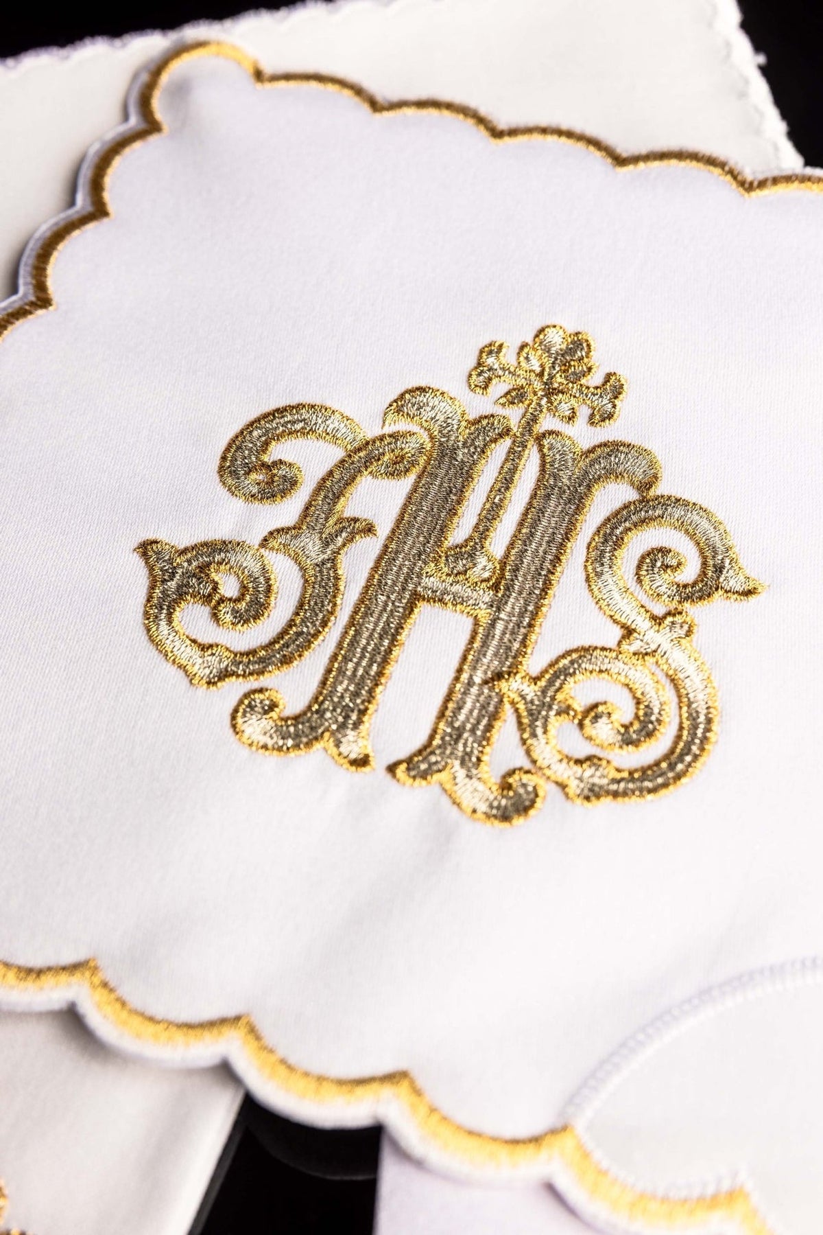 Altar linen set close-up showing gold IHS embroidery and scalloped edging