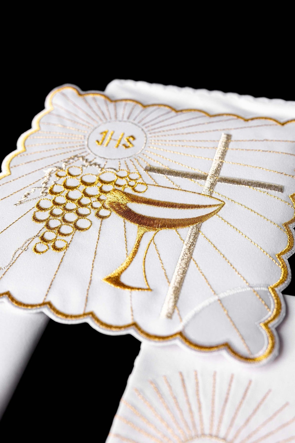 Altar linen set close-up showing gold embroidery of grapes, chalice and cross