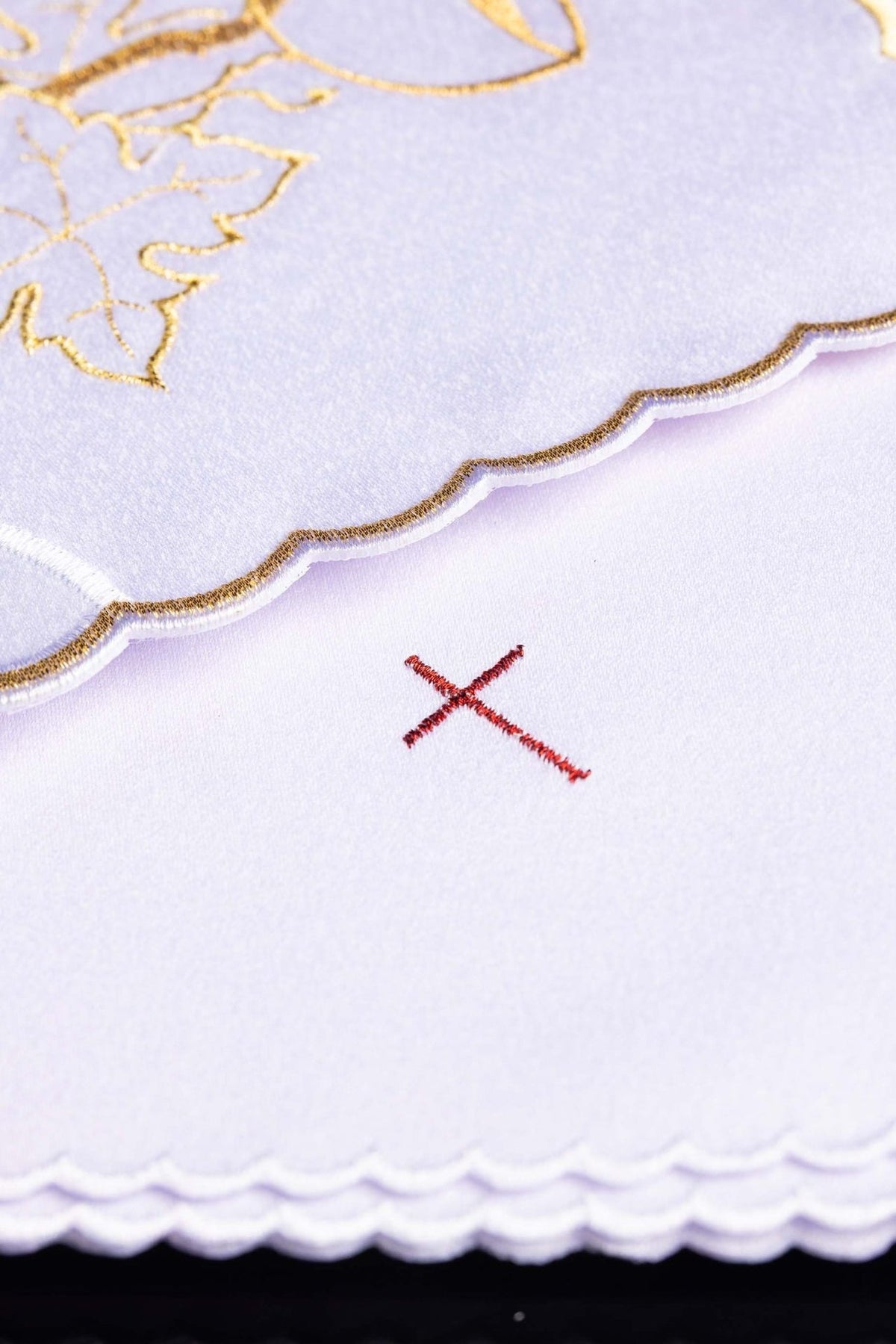 Altar linen set detail showing scalloped gold edging and red cross embroidery