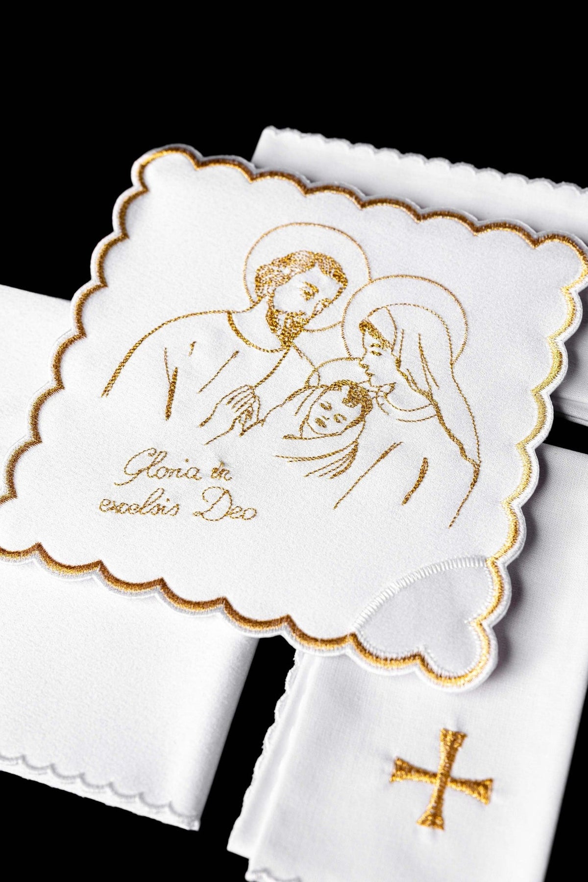 Altar linen set close-up with embroidered gold Holy Family and scalloped edging