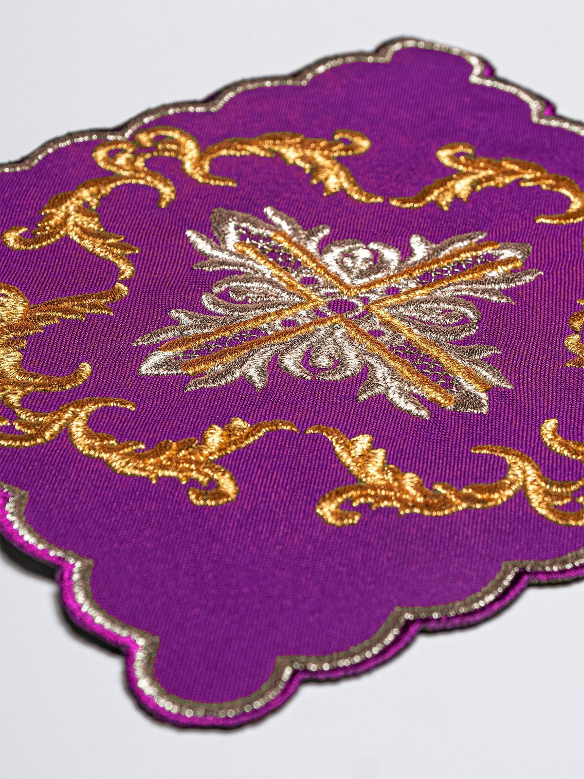 Altar linen set chalice pall close-up with gold and silver embroidery on purple fabric
