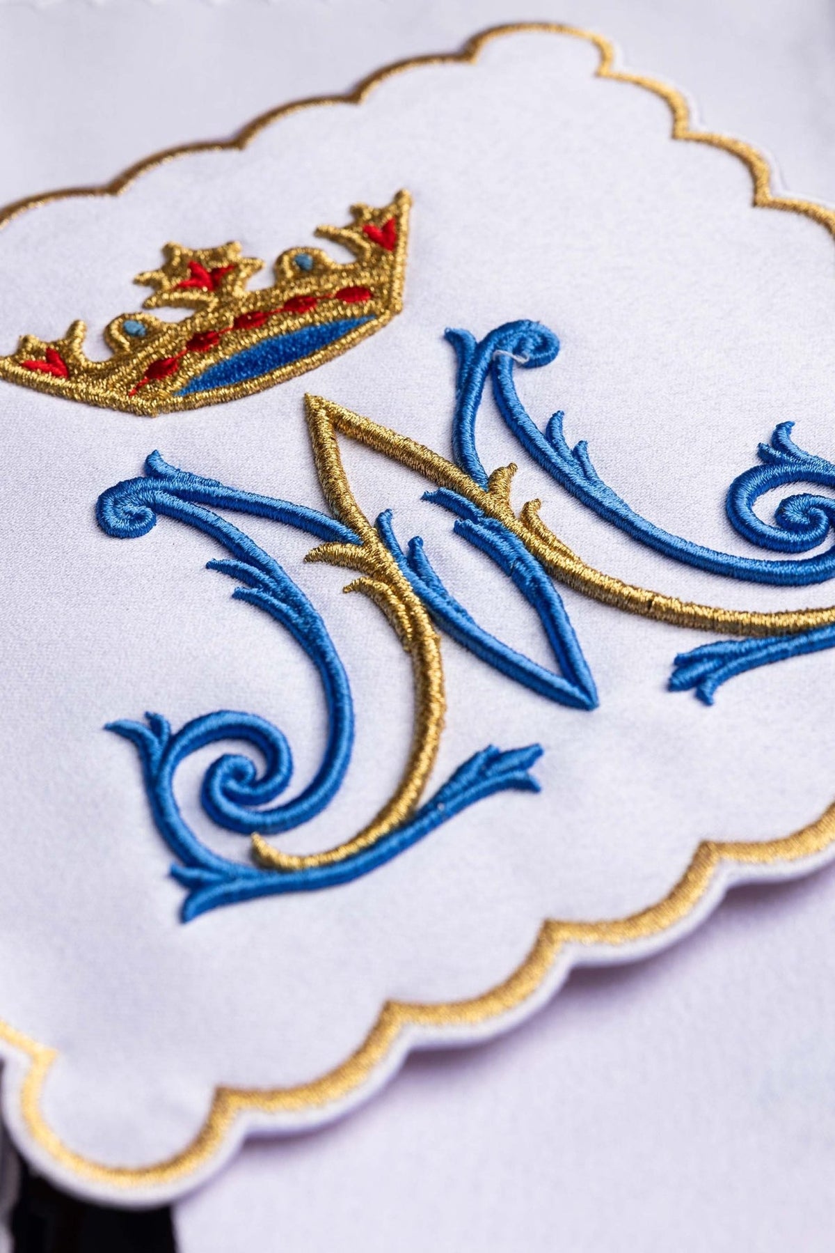 Altar linen set close-up of blue and gold Marian embroidery with a crown