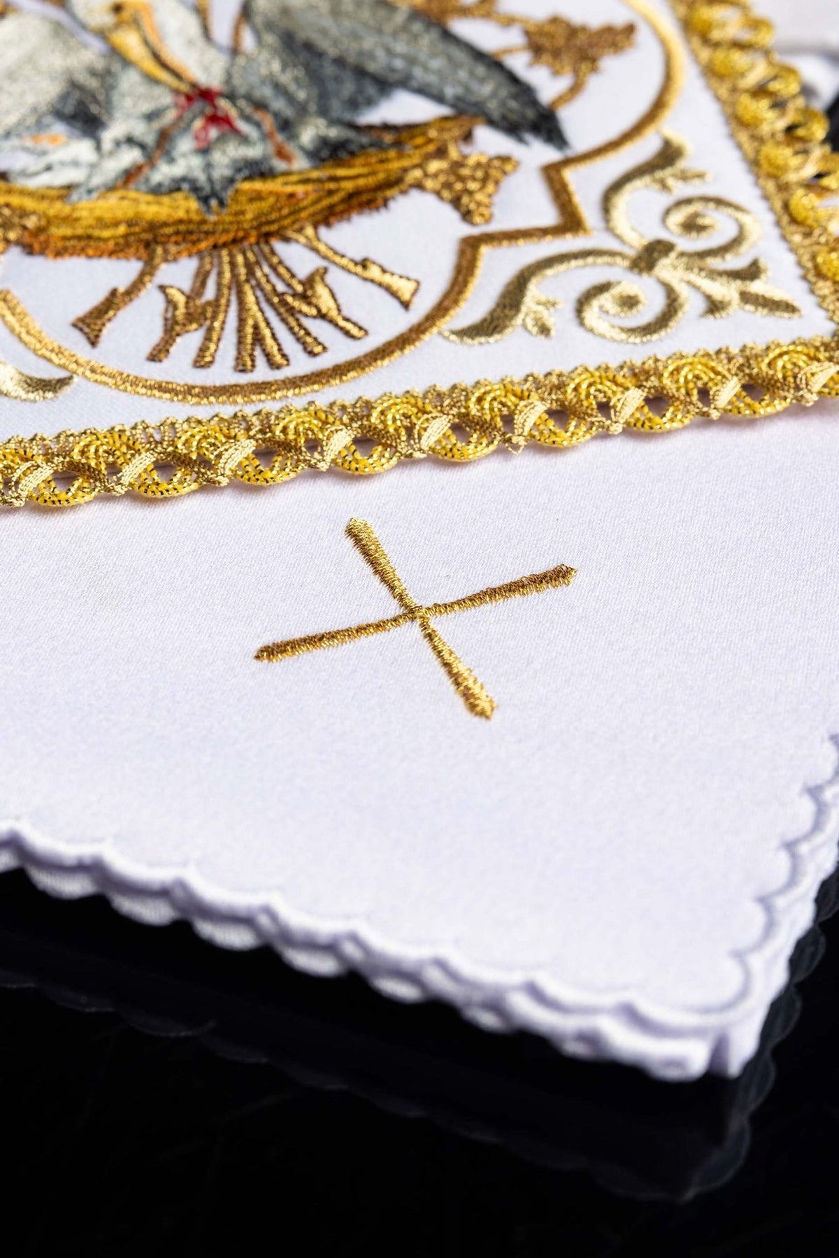 Altar linen set detail showing gold embroidery, scalloped white edge and cross