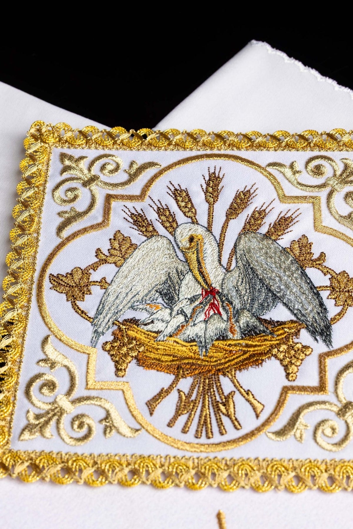 Altar linen set close-up of embroidered pelican and gold decorative border
