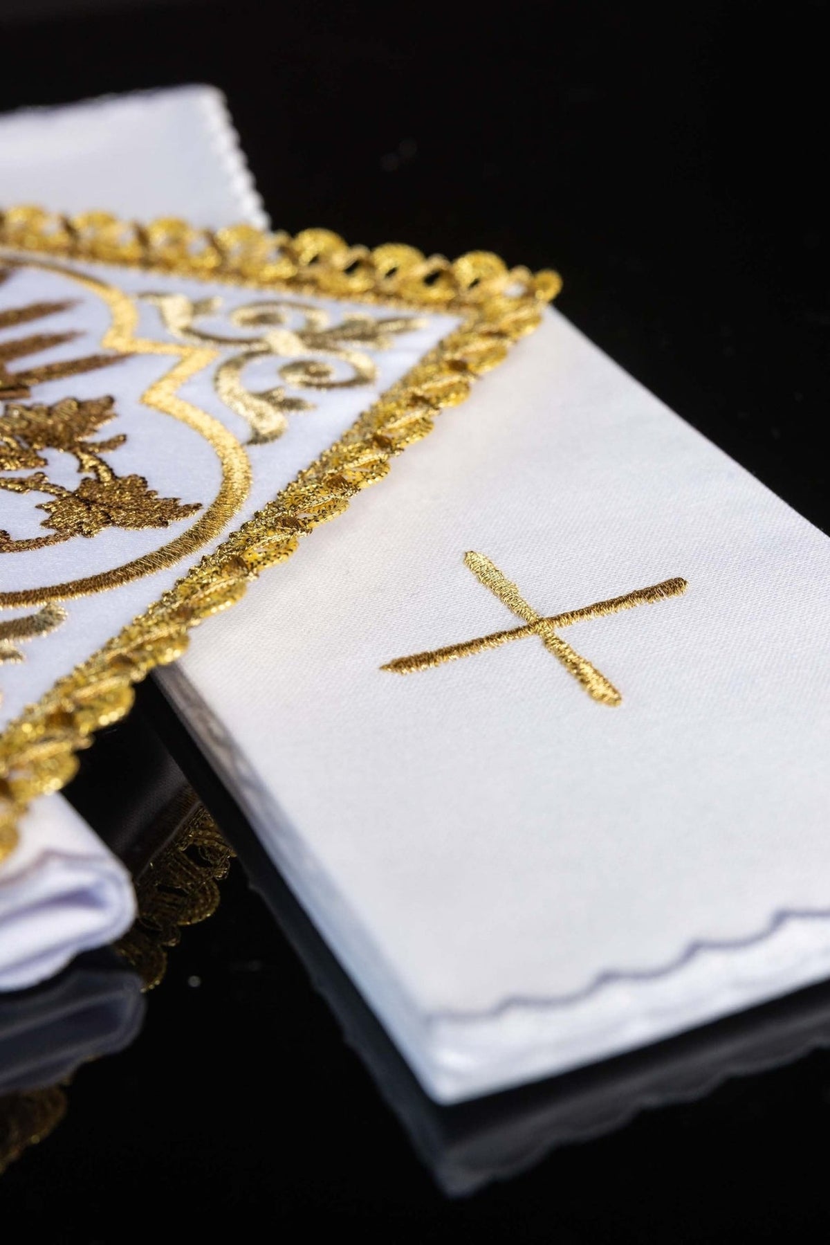 Altar linen set detail showing white linen with gold embroidered cross and trimmed PAX panel