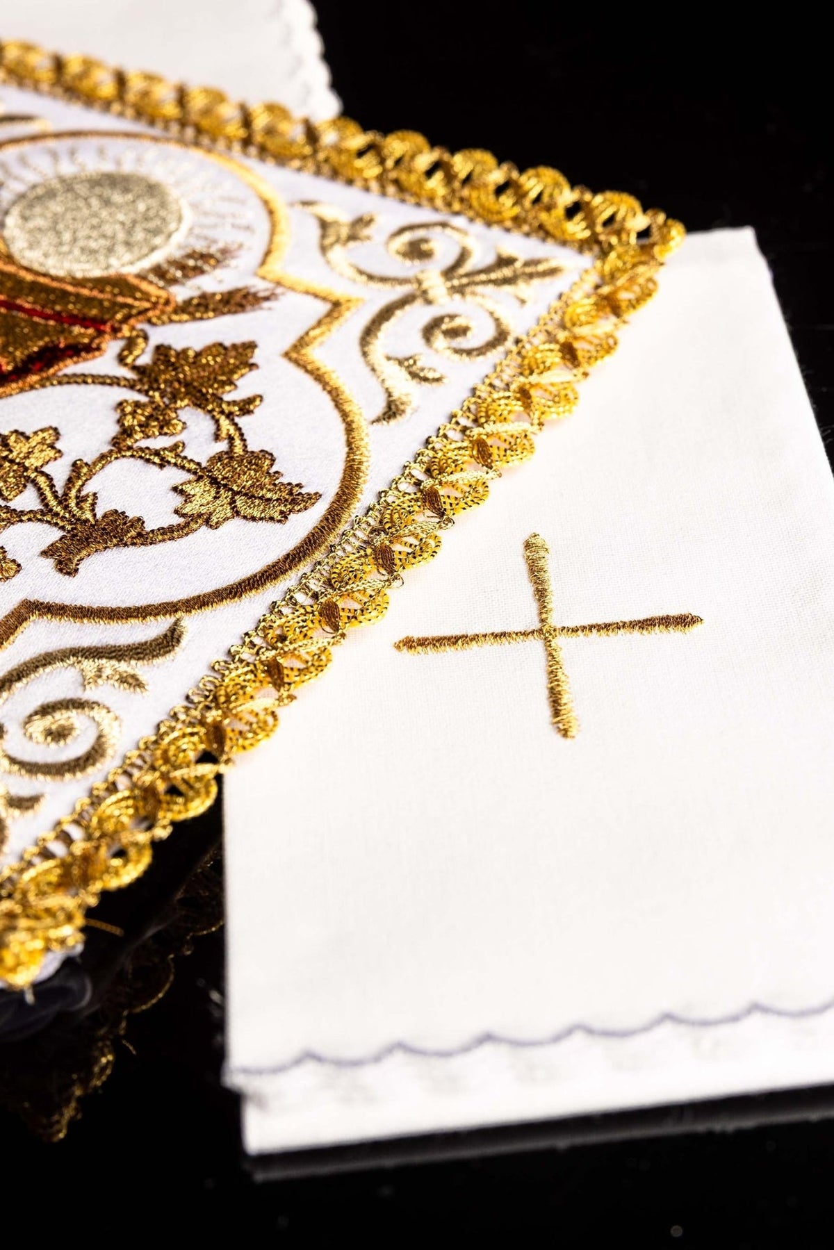 Altar linen set detail showing gold cross embroidery and scalloped white edge