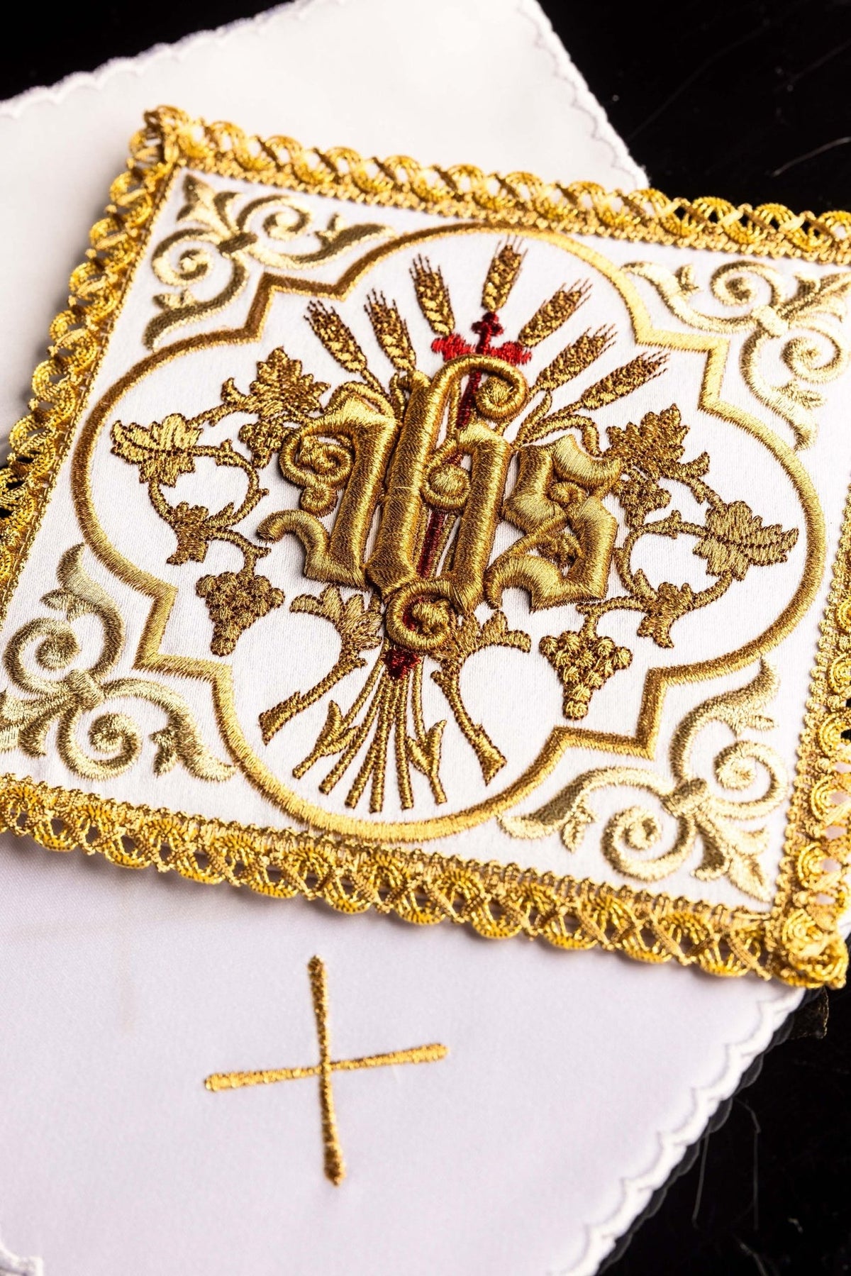 Altar linen set close-up showing gold-edged embroidered IHS symbol on white linen