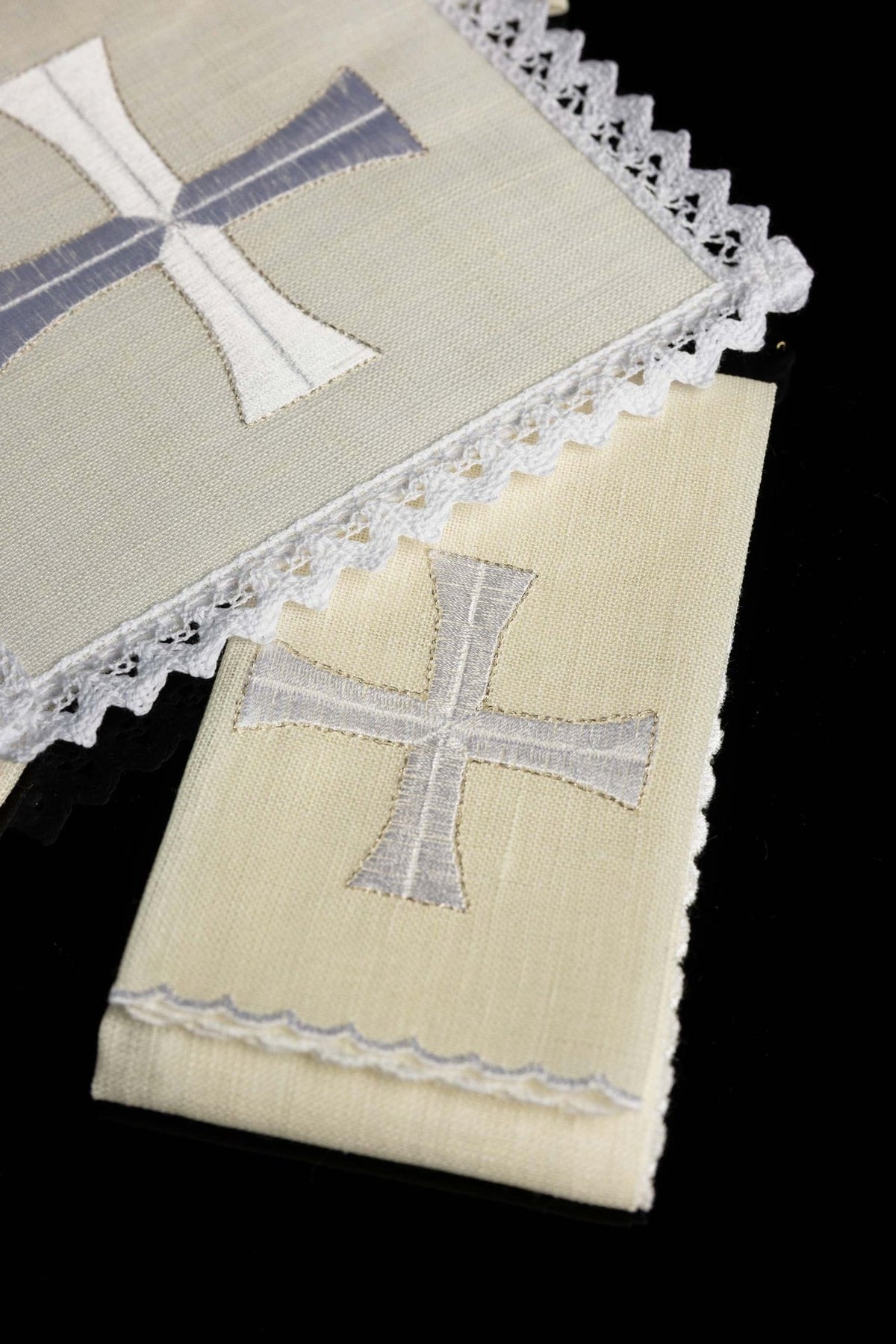 Altar linen set detail showing silver cross embroidery on an ivory linen piece