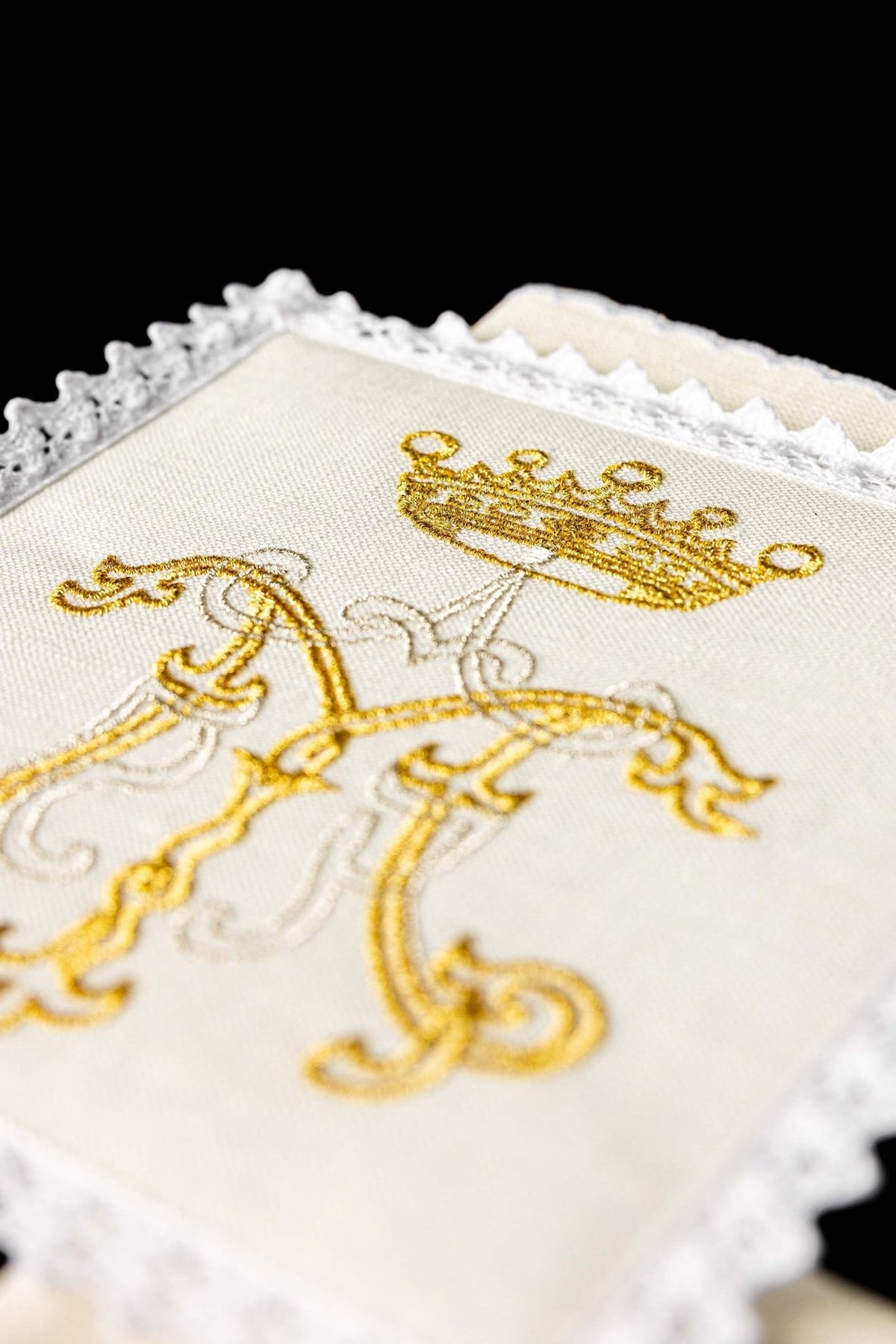 Altar linen set close-up of gold Marian embroidery and lace-edged linen
