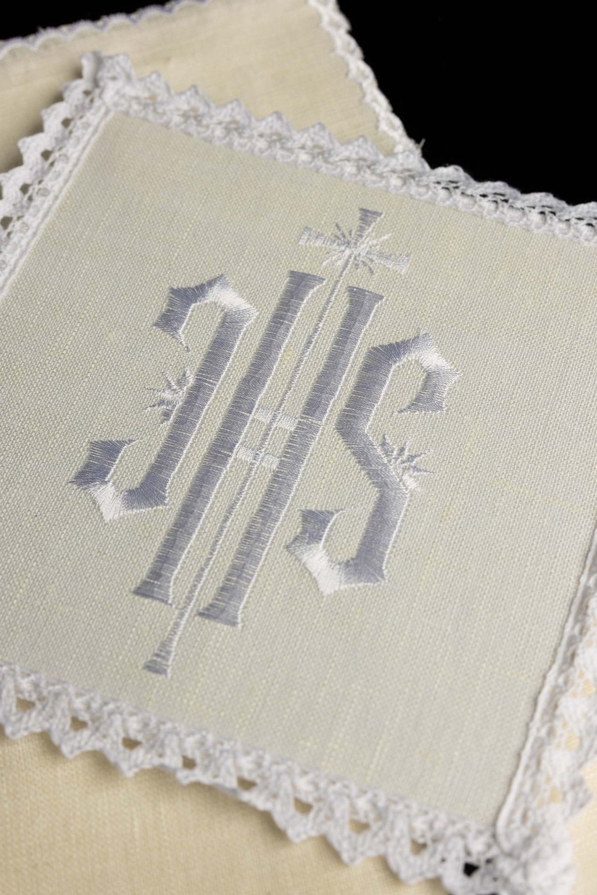 Altar linen set close-up showing embroidered IHS and lace trim