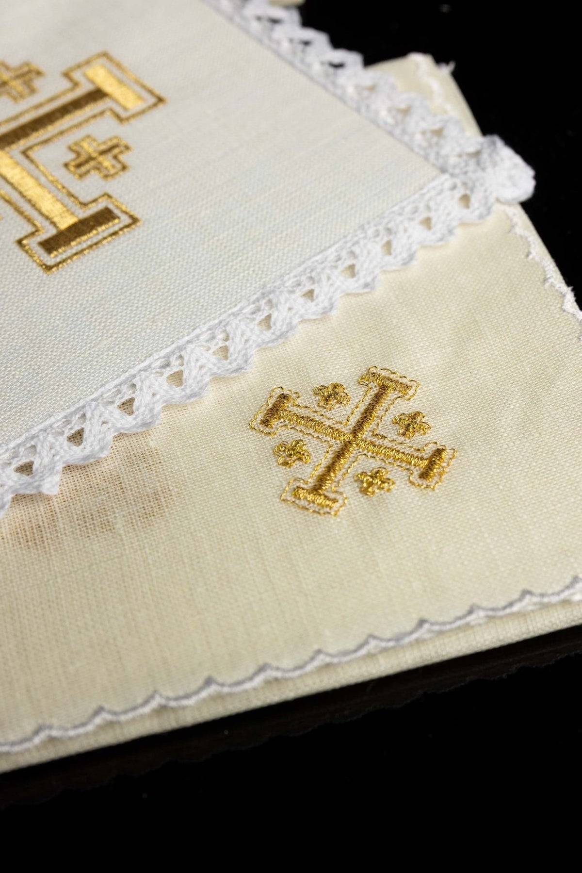 Altar linen set close-up showing gold cross embroidery on ivory linen and scalloped edging