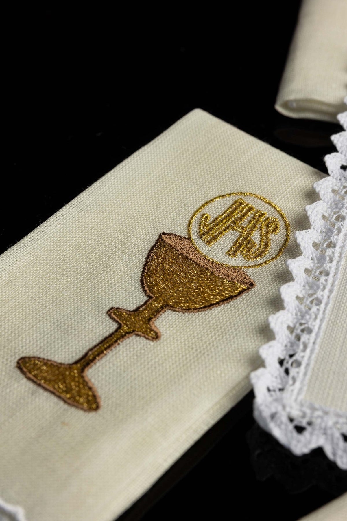 Altar linen set close-up of gold embroidered chalice motif with Eucharistic monogram